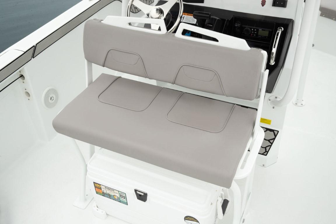 2024 Wellcraft 202 Fisherman boat interior with cushioned seating and steering console.