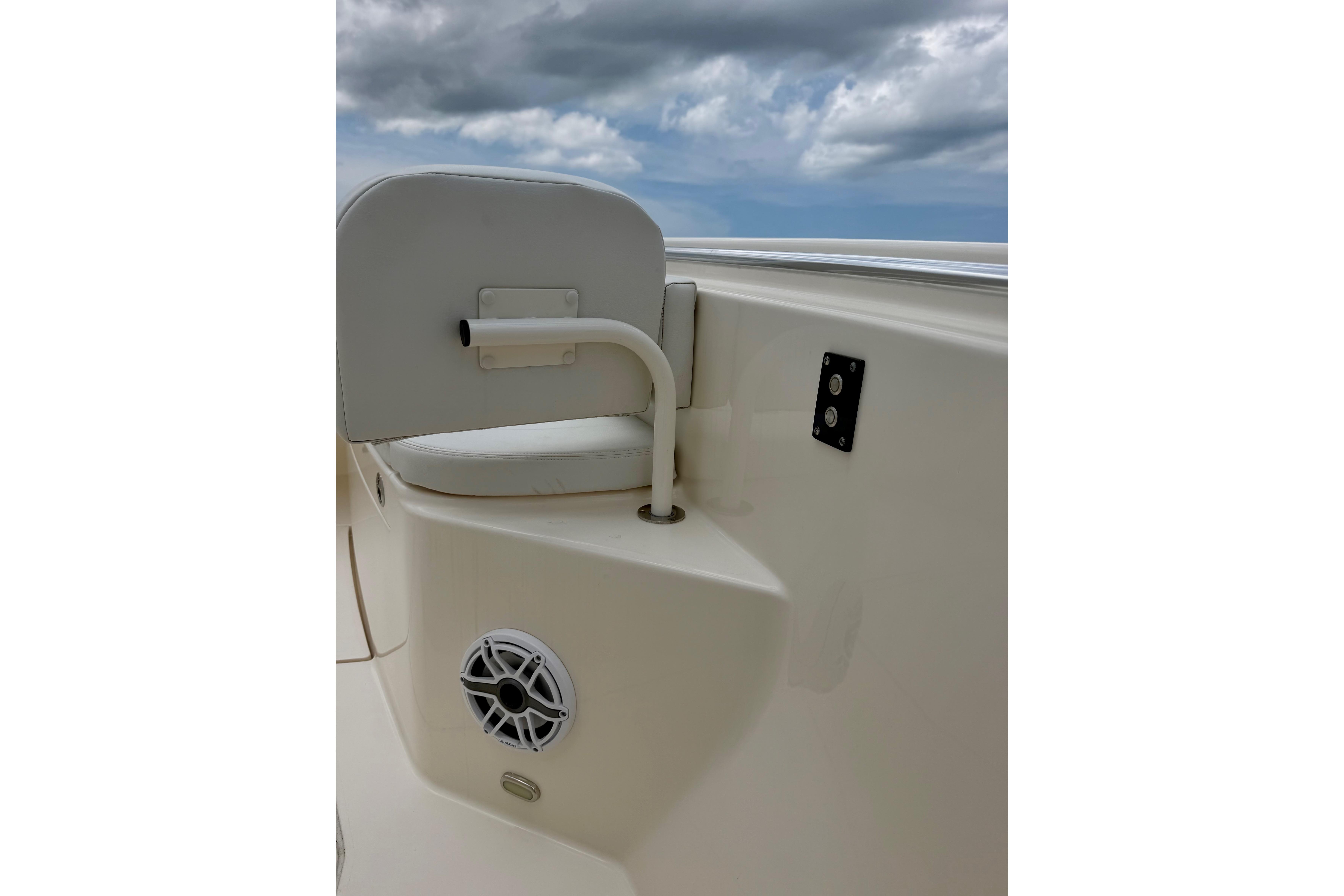 2023 Cobia 350 Center Console boat interior with seating and speaker, under cloudy sky.