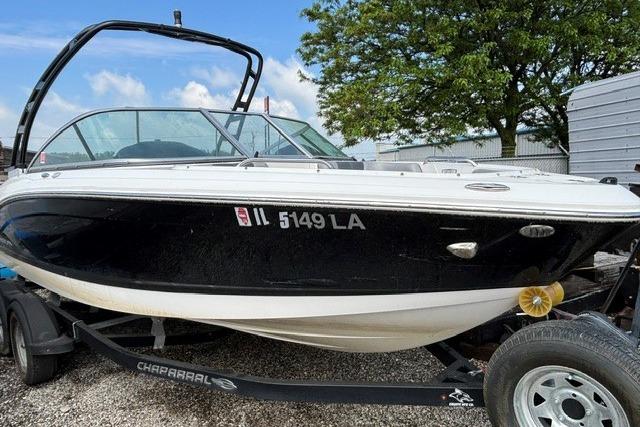 2021 Chaparral 21 SSi boat on trailer, black and white exterior, parked outdoors.