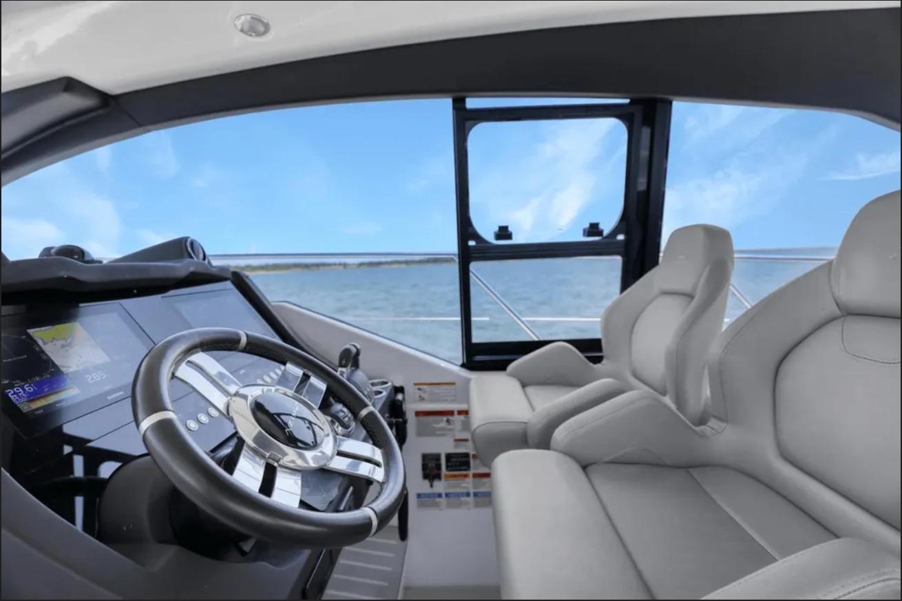 Interior view of 2020 Azimut 51 Atlantis yacht cockpit with steering wheel and seating.