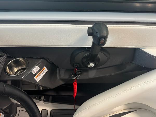 Interior view of 2018 Monterey 258 Super Sport boat controls and cup holder.