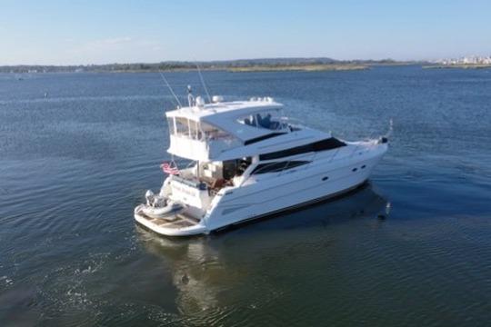 2005 Neptunus 56 Flybridge yacht cruising on calm waters.
