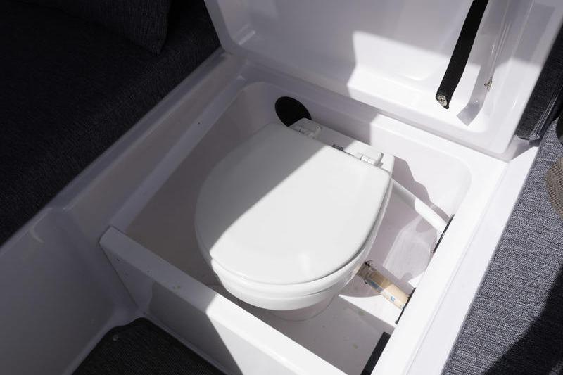 2025 Axopar 29 XC Cross Cabin boat toilet compartment, featuring a compact white toilet.