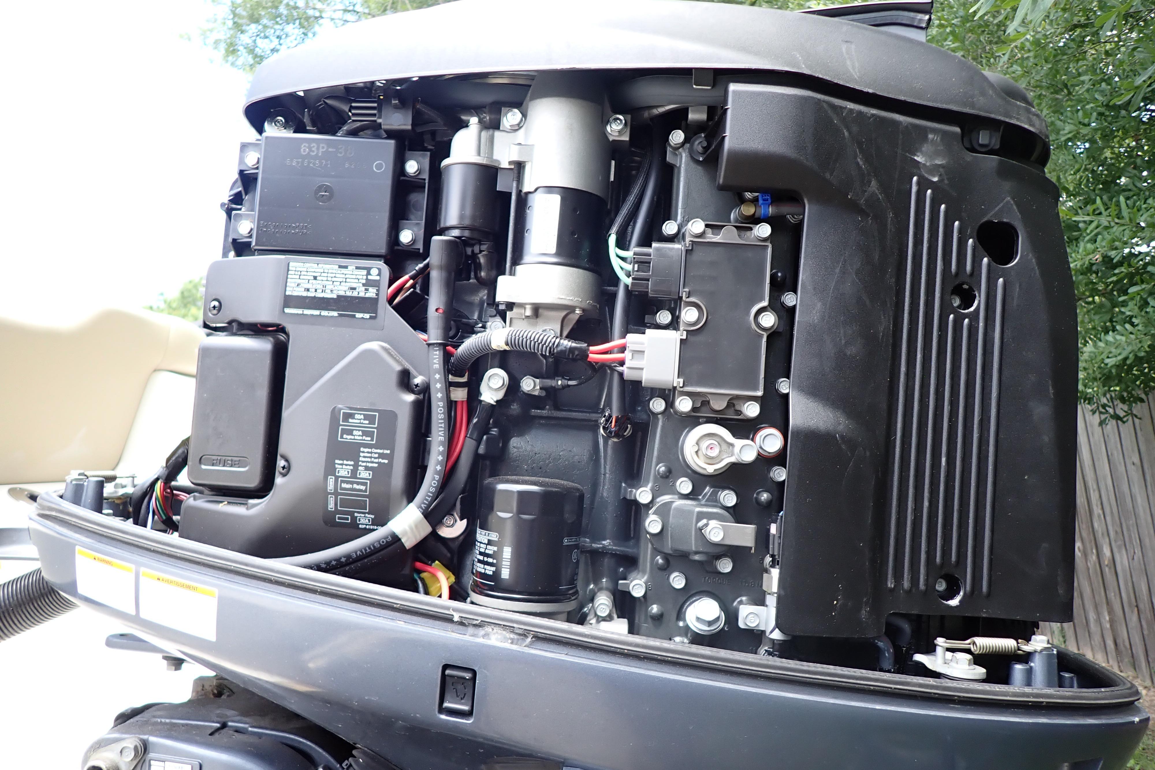 Close-up of a 2019 Key West 263 FS boat engine, showcasing intricate components.