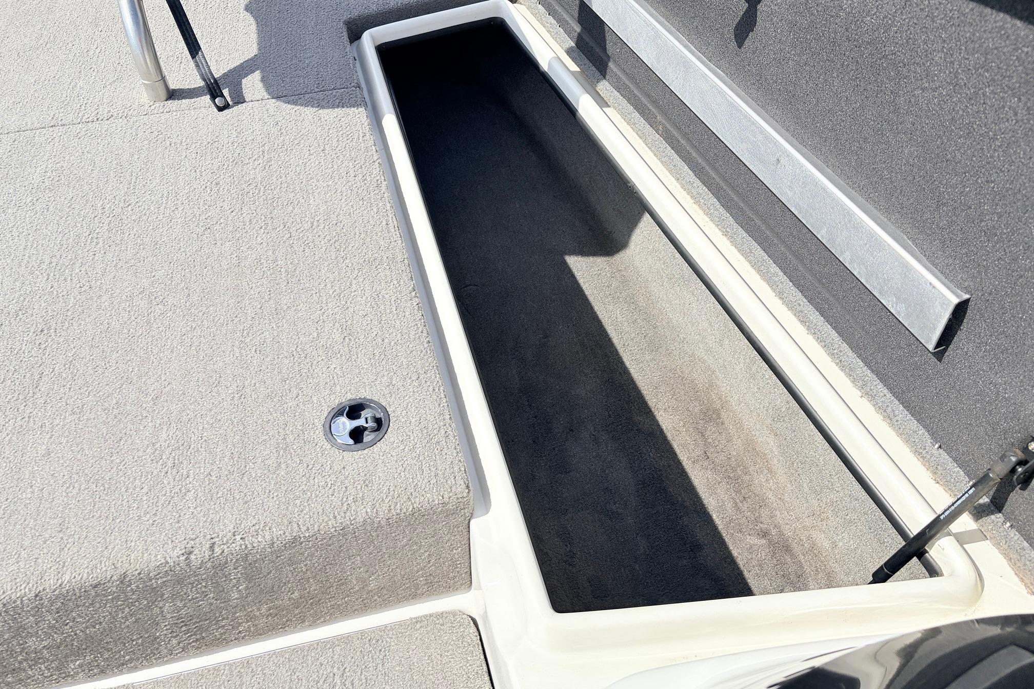 2011 Nitro Z-7 boat storage compartment with carpeted interior and latch.