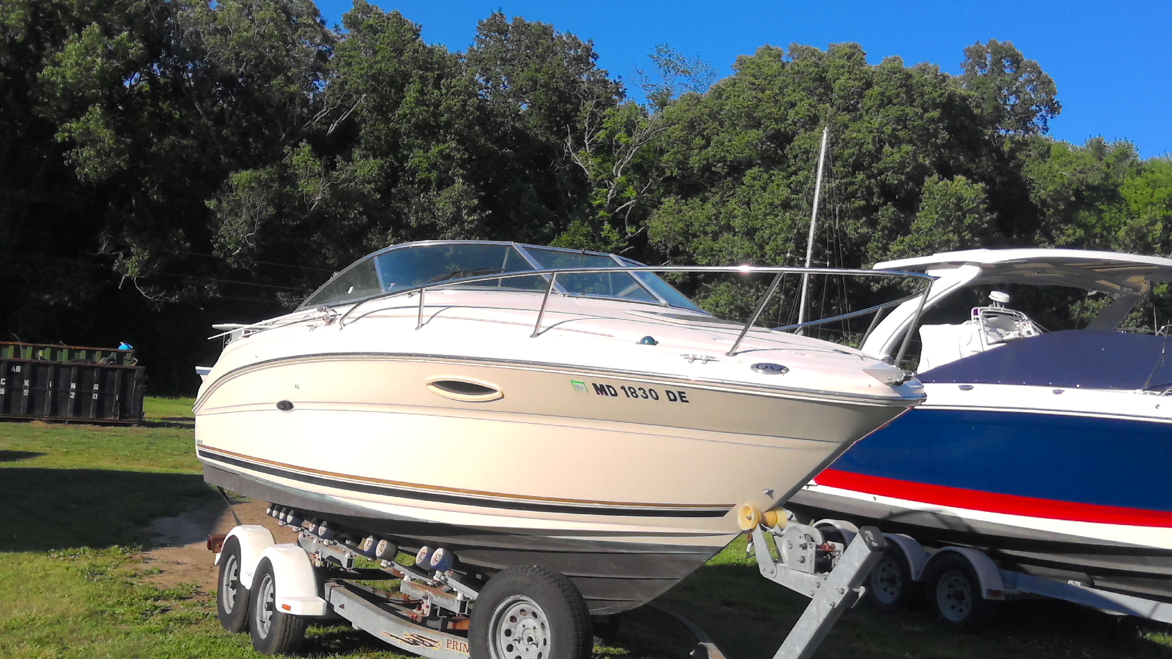 2004 Sea Ray 225 Weekender on trailer outdoors.
