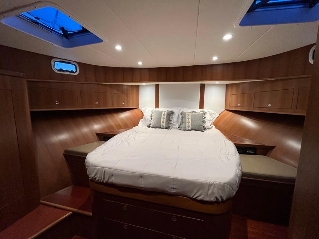 Luxurious 2025 Bracewell 41 yacht cabin with cozy bed and elegant wood finish.