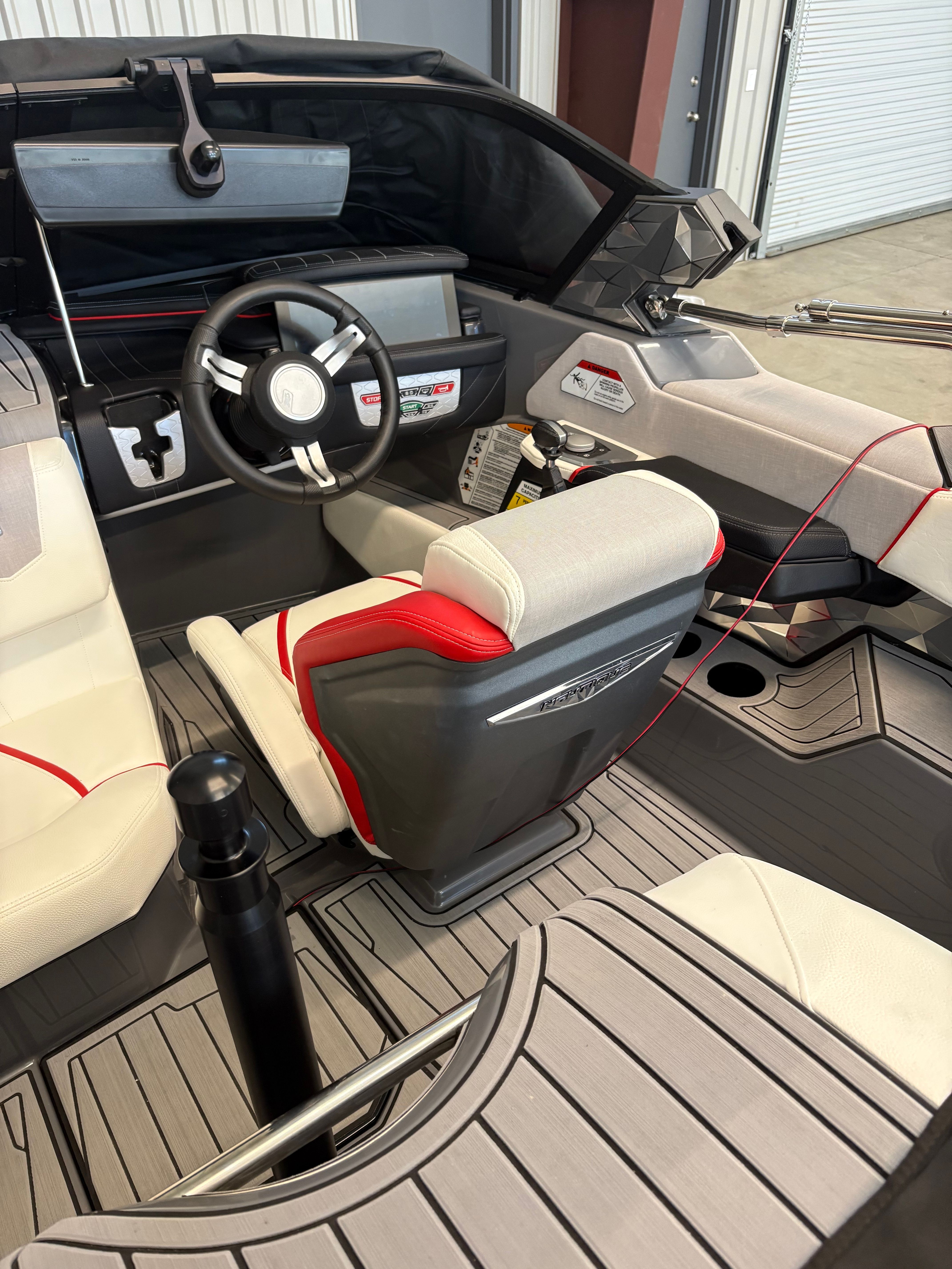 The interior of a 2023 Nautique Ski Nautique with a modern steering wheel and sleek seating.