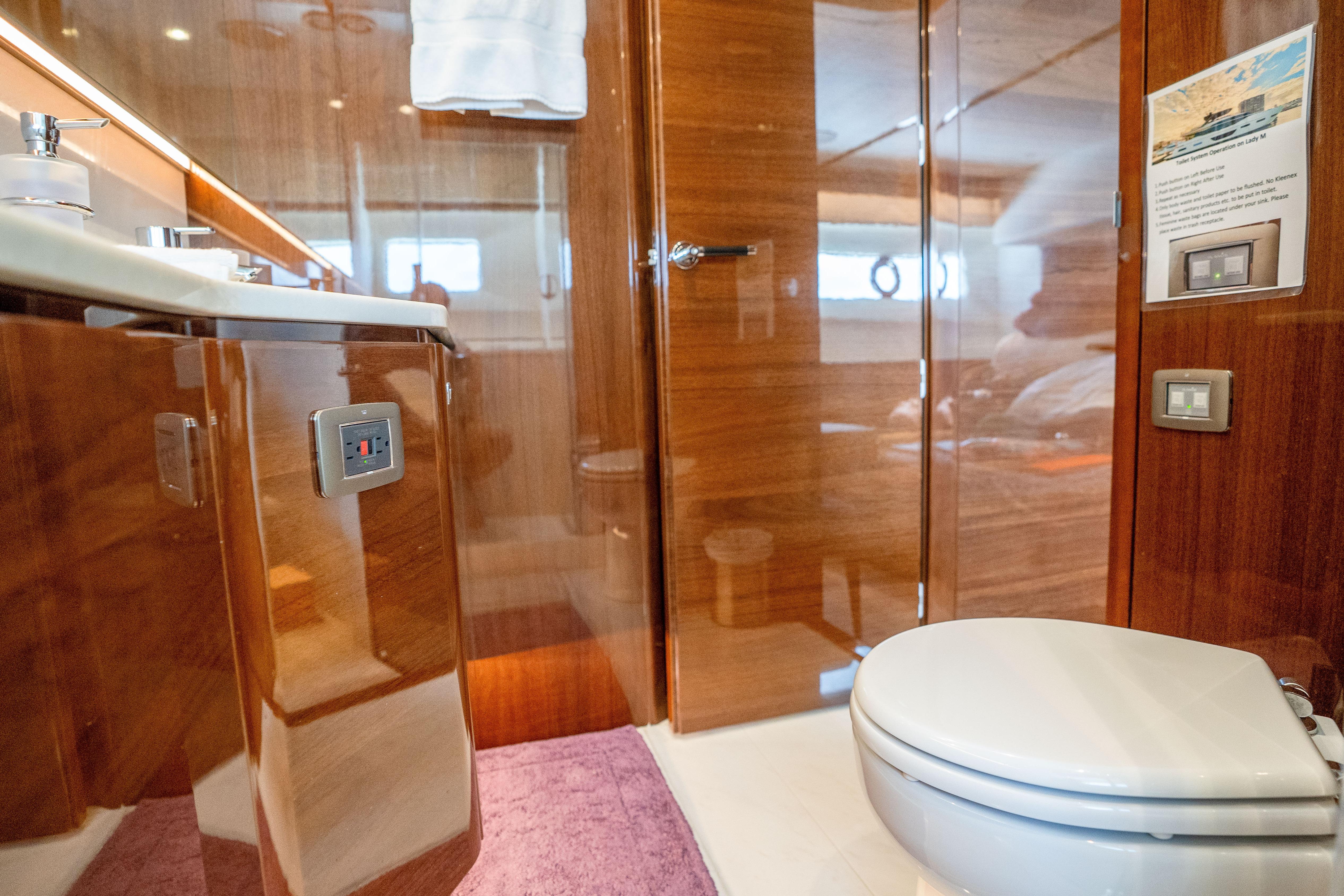 Luxurious bathroom interior on 2020 Princess Y85 yacht with wooden finishes and modern amenities.