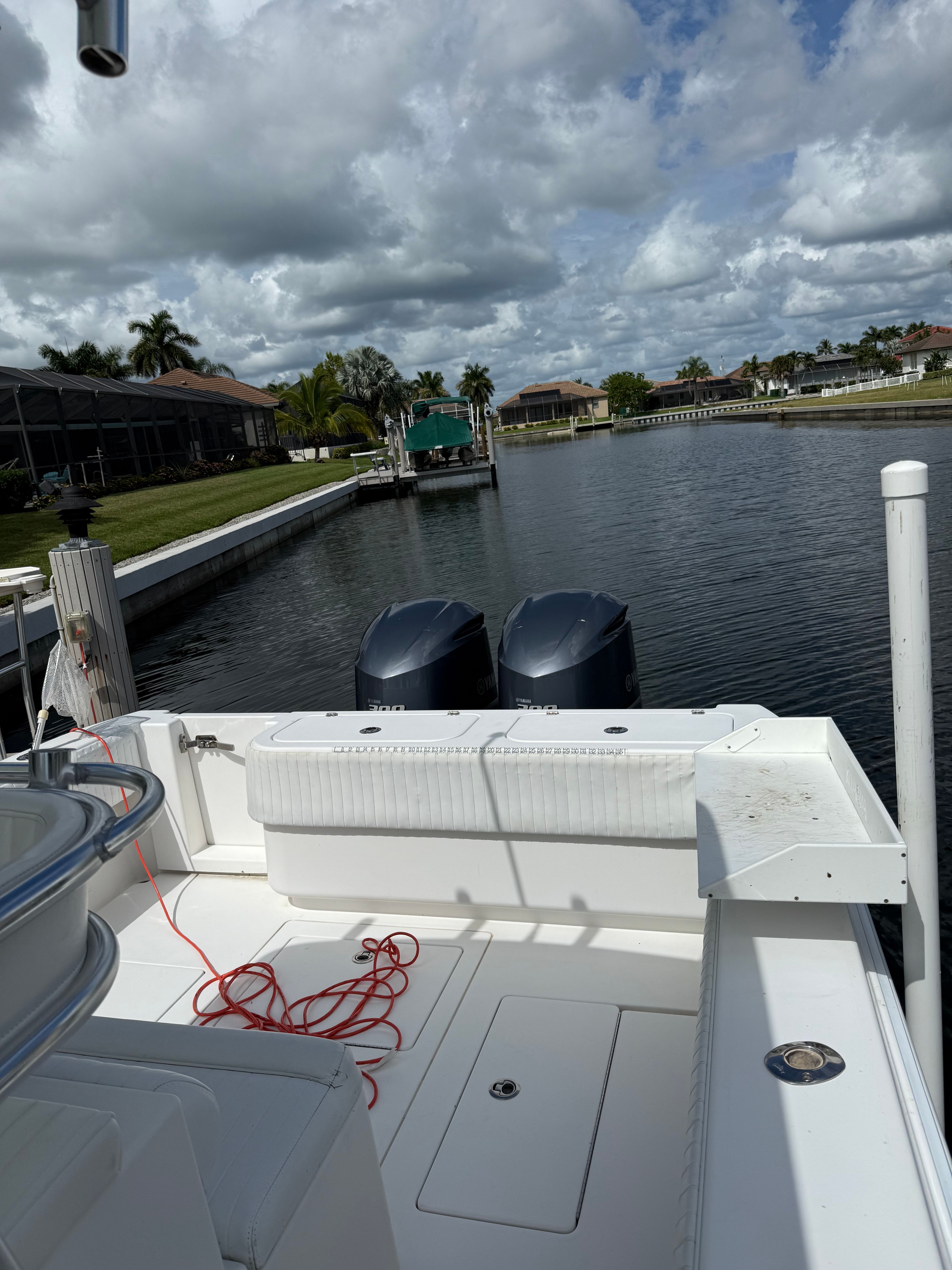 2012 Contender 32 ST boat on a calm canal.