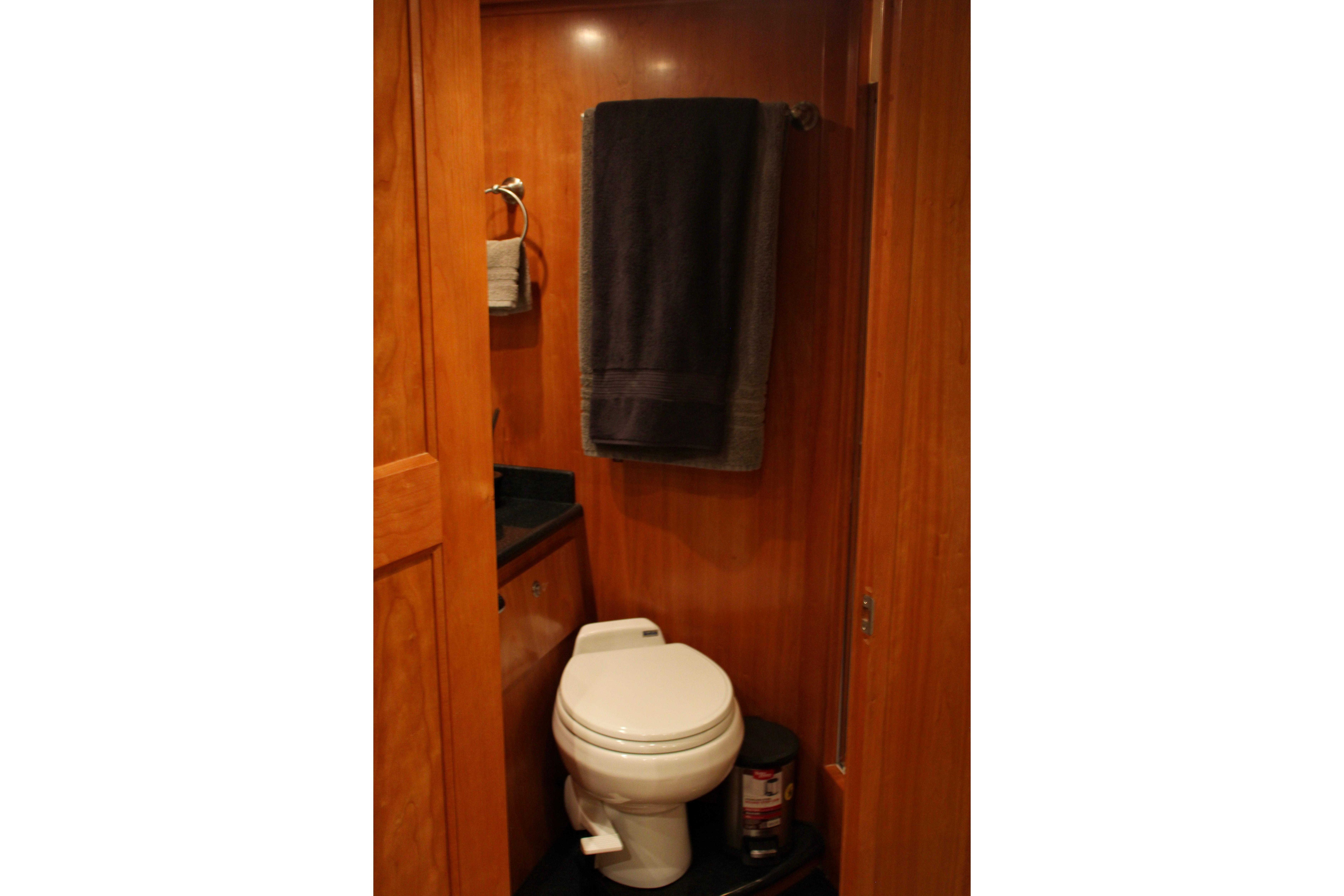 Compact wooden bathroom interior on a 2007 Navigator 5100 yacht.