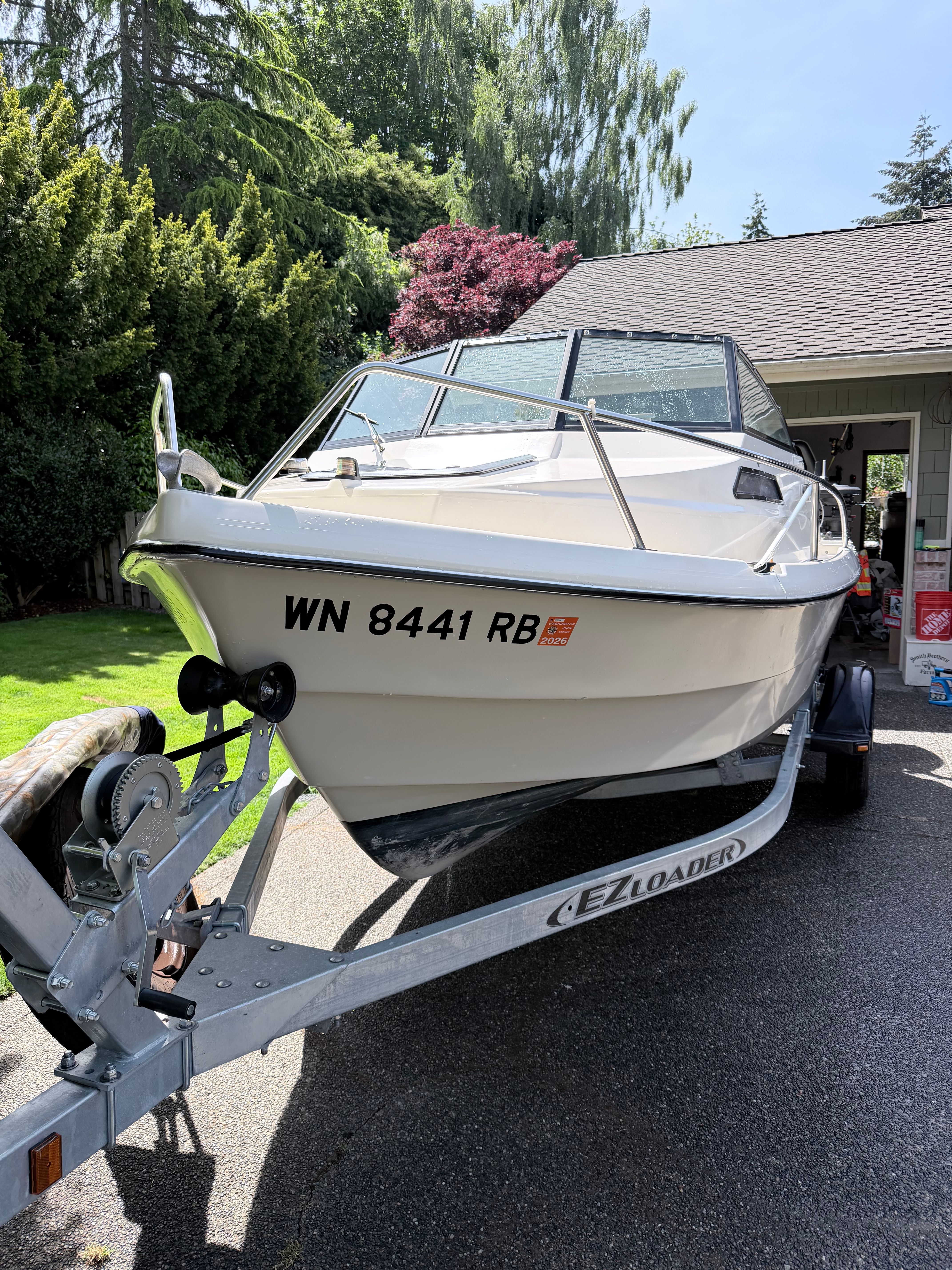 A 1993 Arima Sea Explorer 1511 on a trailer in a driveway.