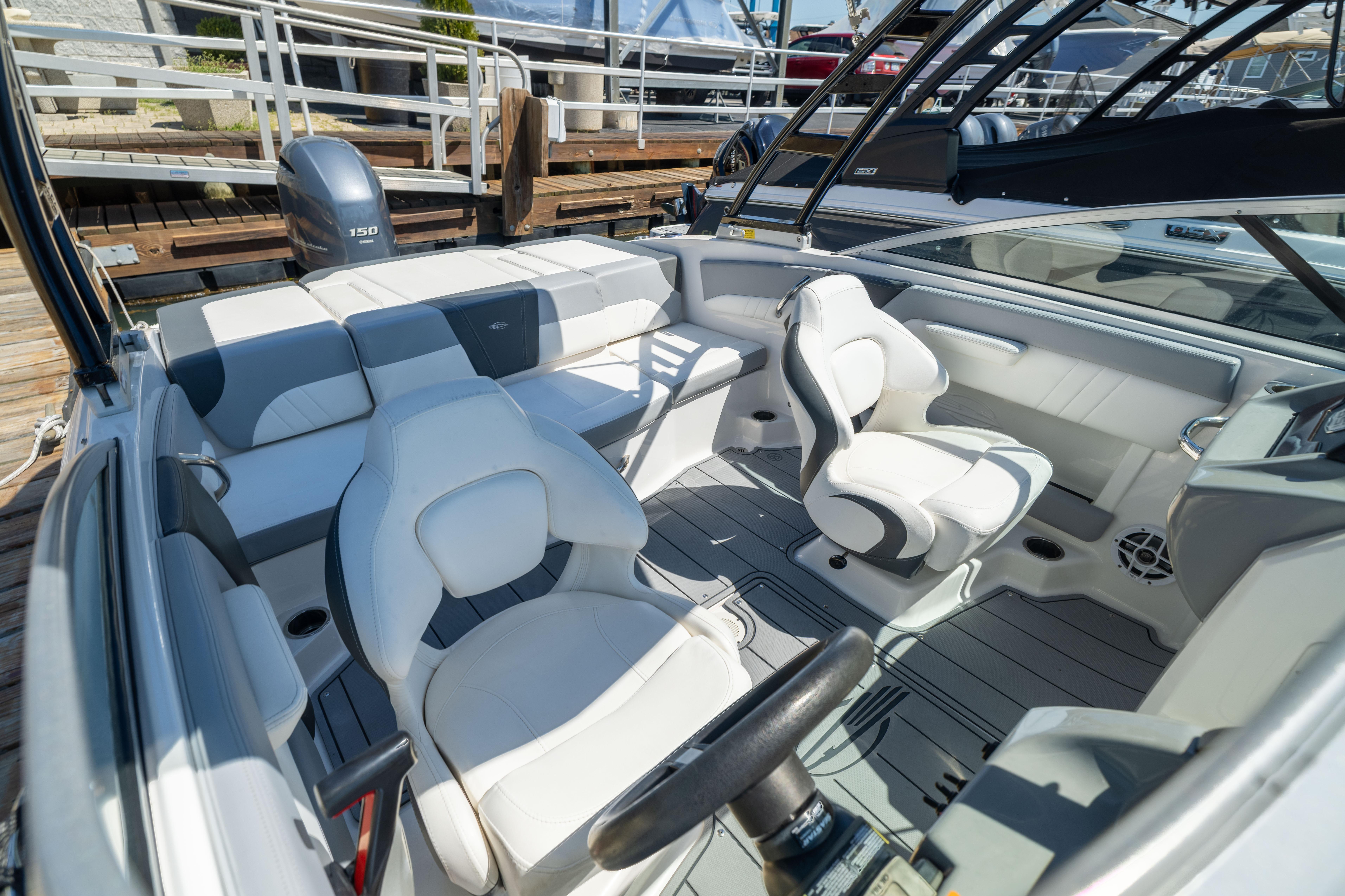 2022 Chaparral 21 SSi OB boat interior with white seating and modern design.