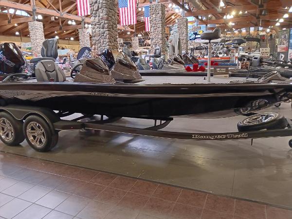 2025 Ranger ALPHA 208 boat displayed indoors with American flags in the background.