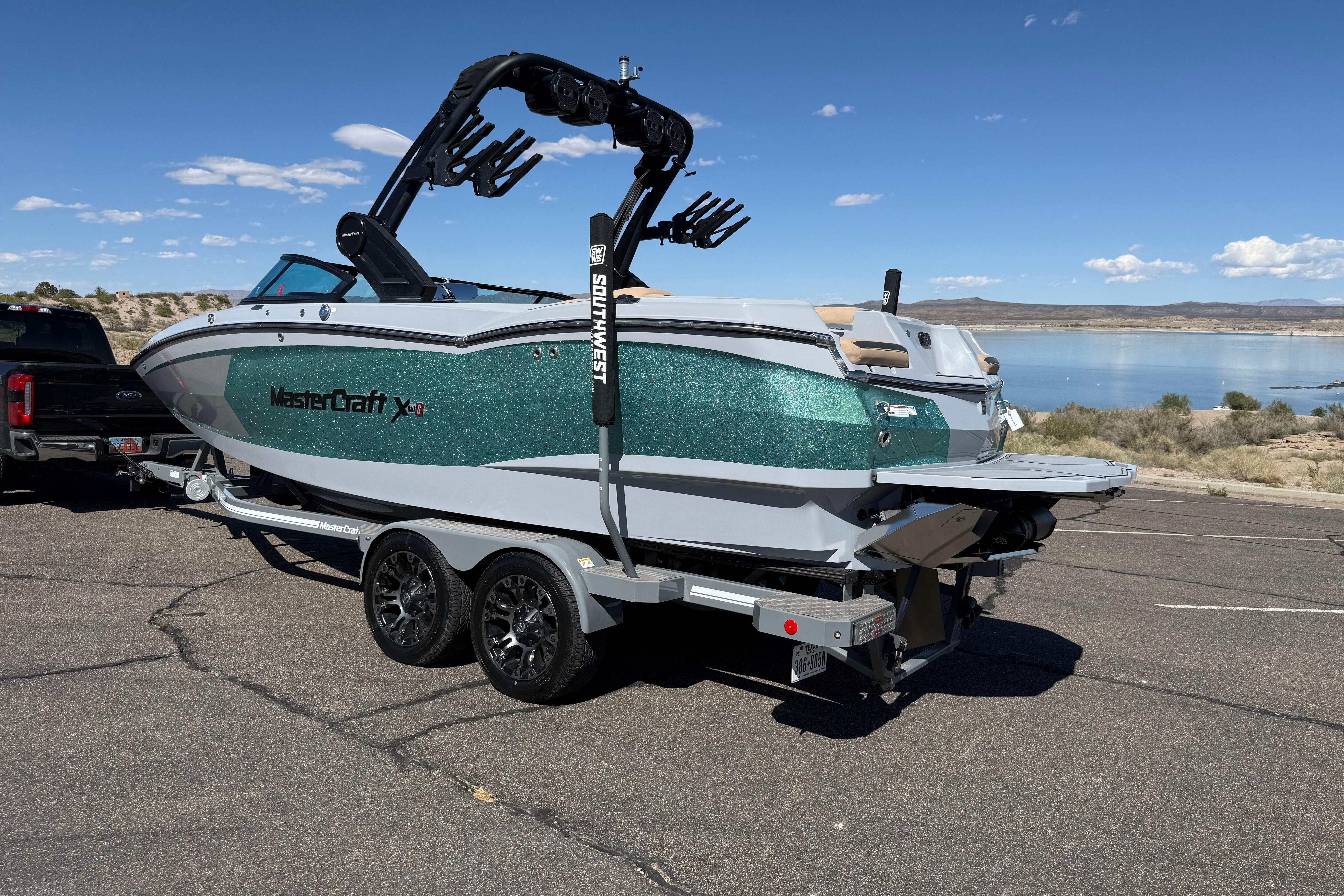2022 MasterCraft XStar boat on trailer near scenic lake view.