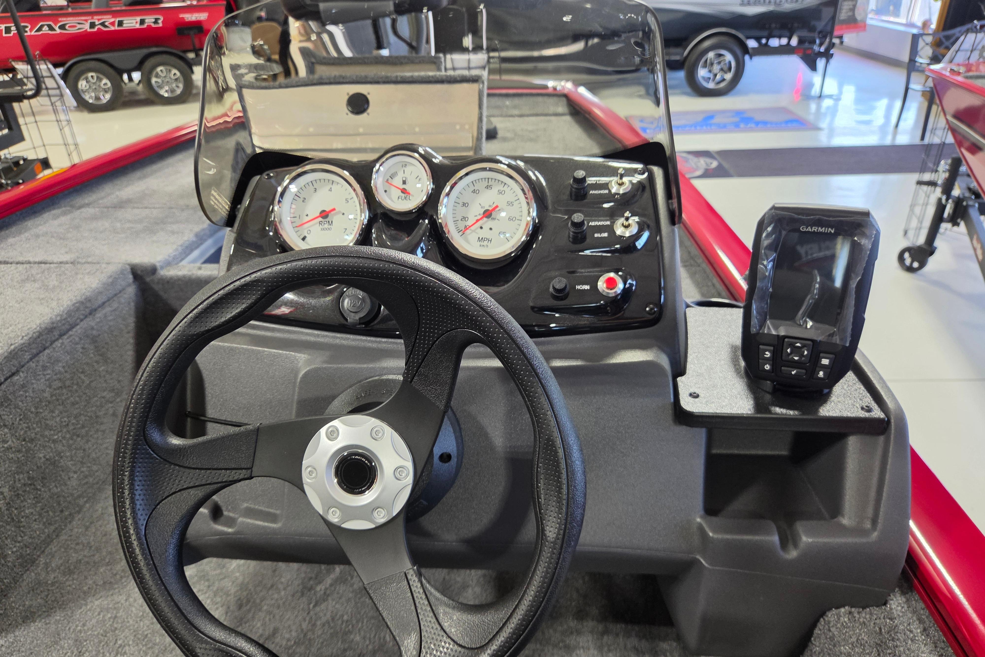 Steering console of 2026 Tracker Pro 170 boat with gauges and Garmin device.