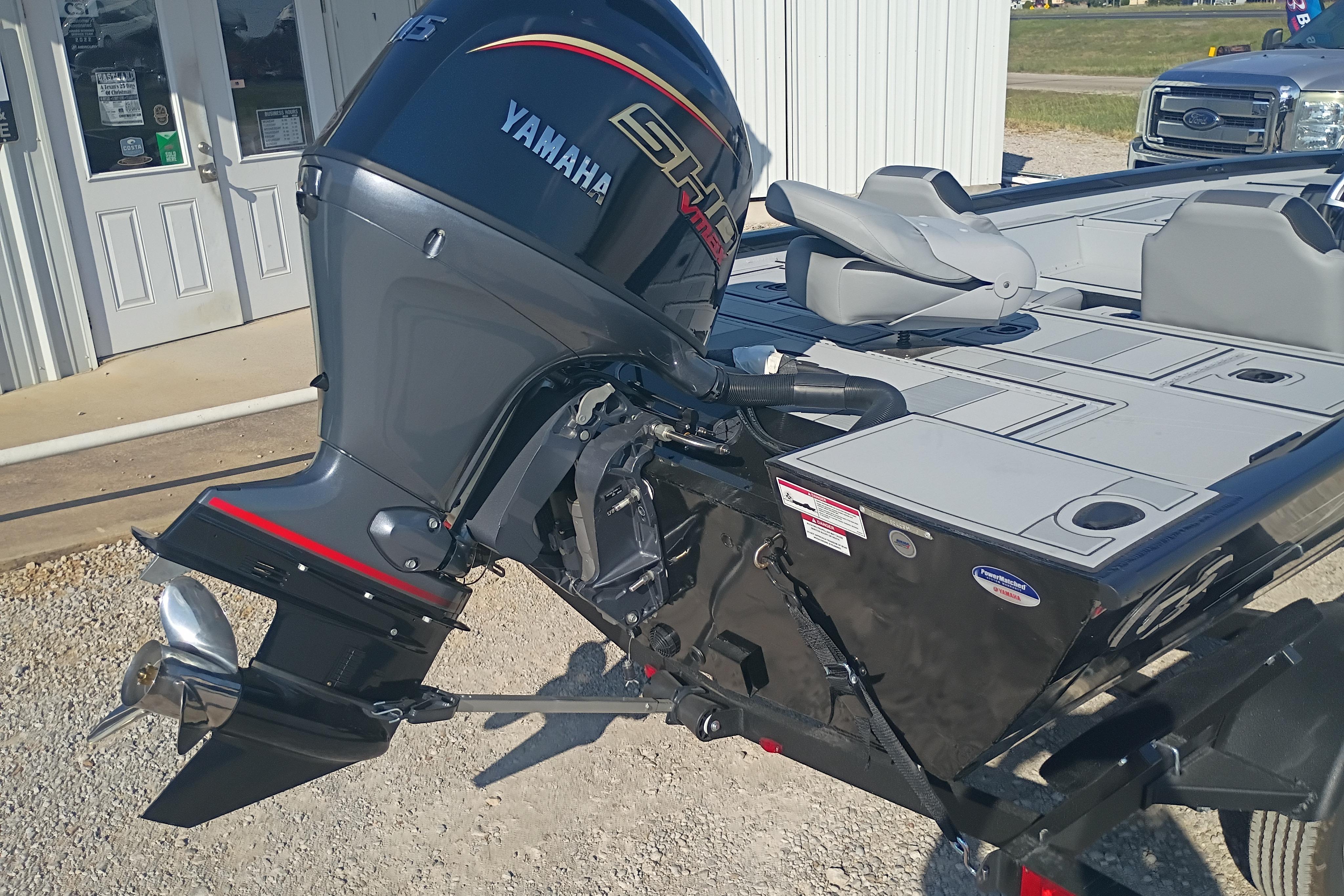 2026 G3 1810SE boat with Yamaha outboard motor, parked outside a building.
