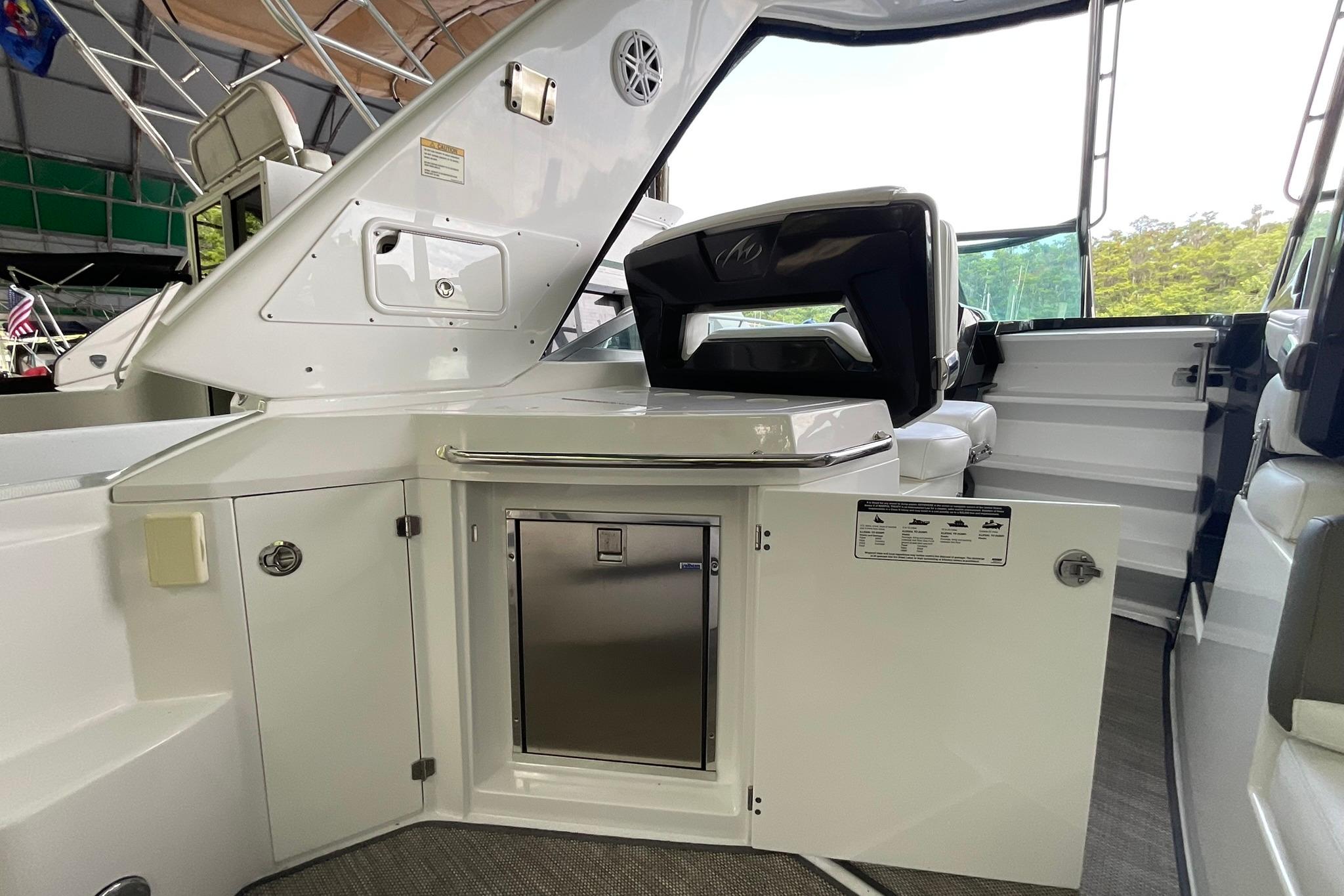2019 Monterey 335 Sport Yacht interior with open cabinet and sleek seating.