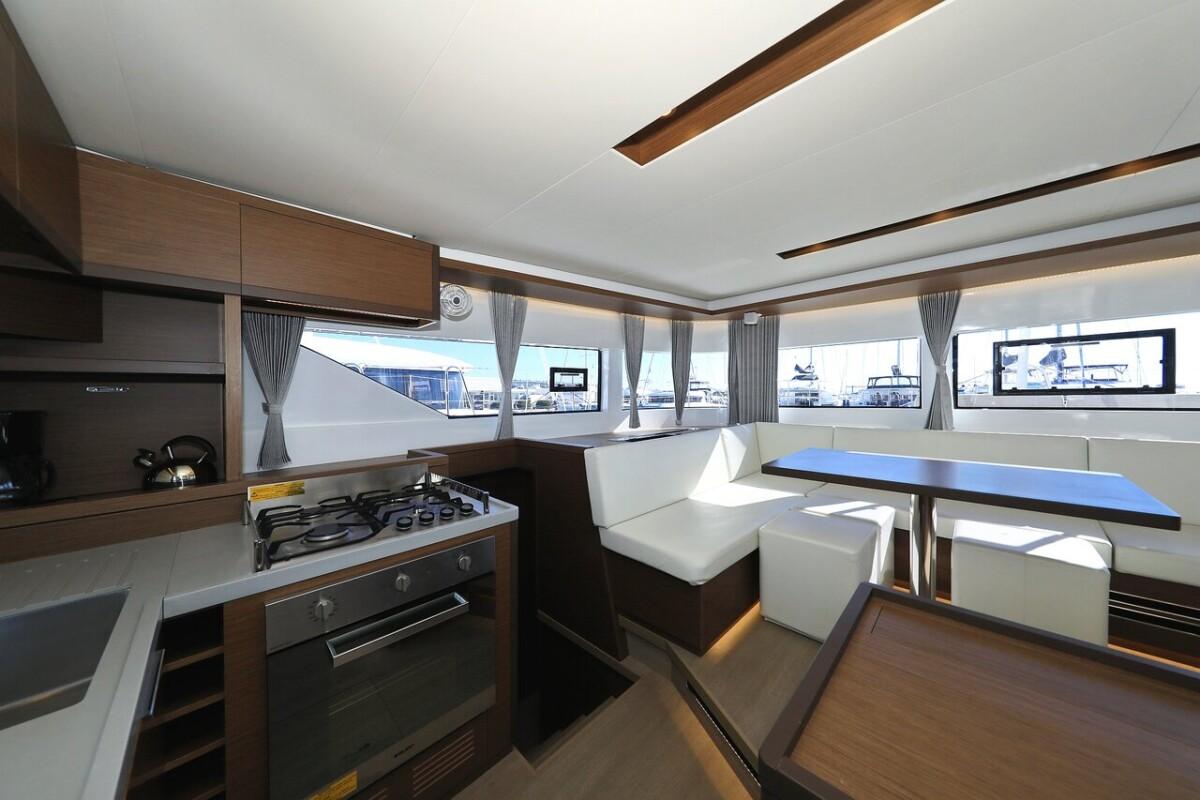 Interior of 2021 Lagoon 50 yacht with modern kitchen and dining area.