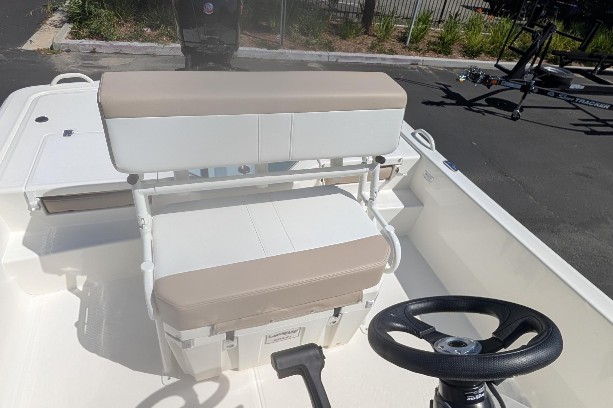 2026 Mako Pro Skiff 19 CC boat interior with beige and white seating, steering wheel visible.