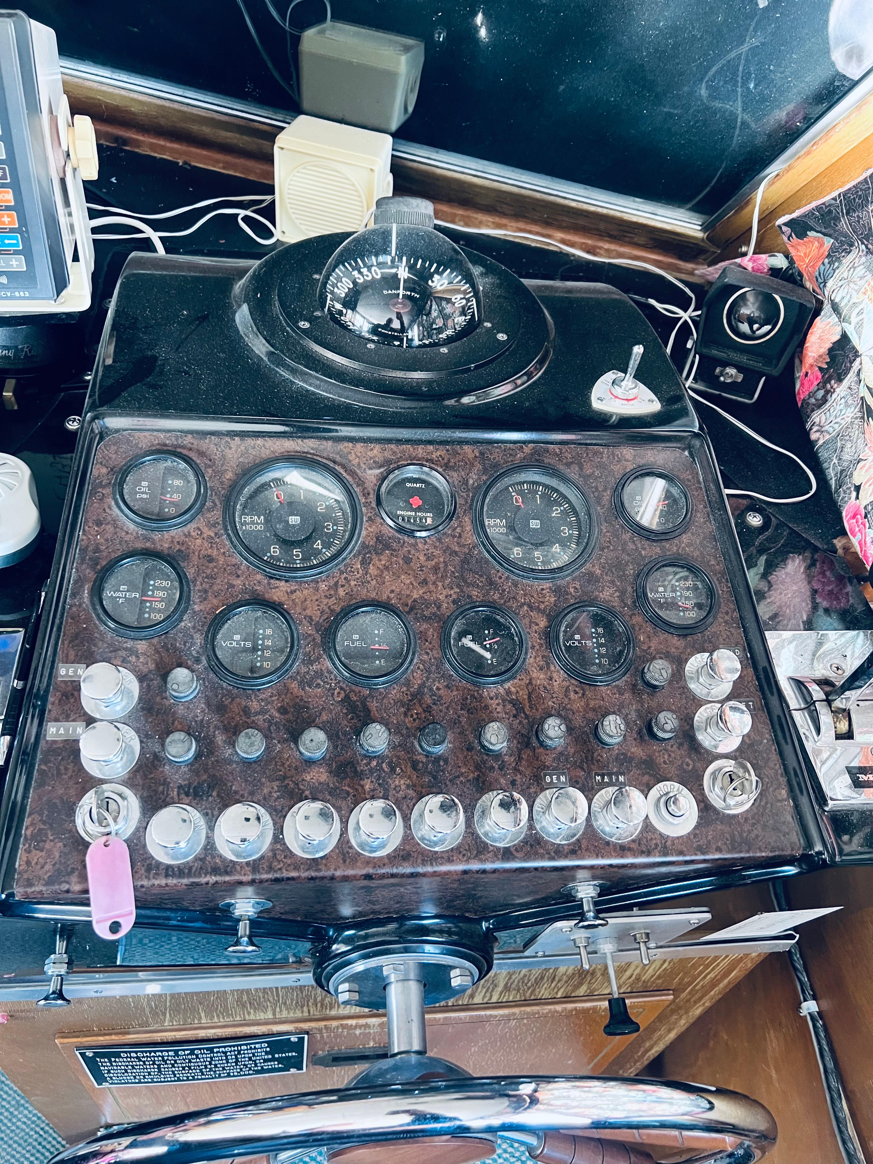 1974 Tollycraft 40 Tri-Cabin Motoryacht dashboard with gauges and controls.