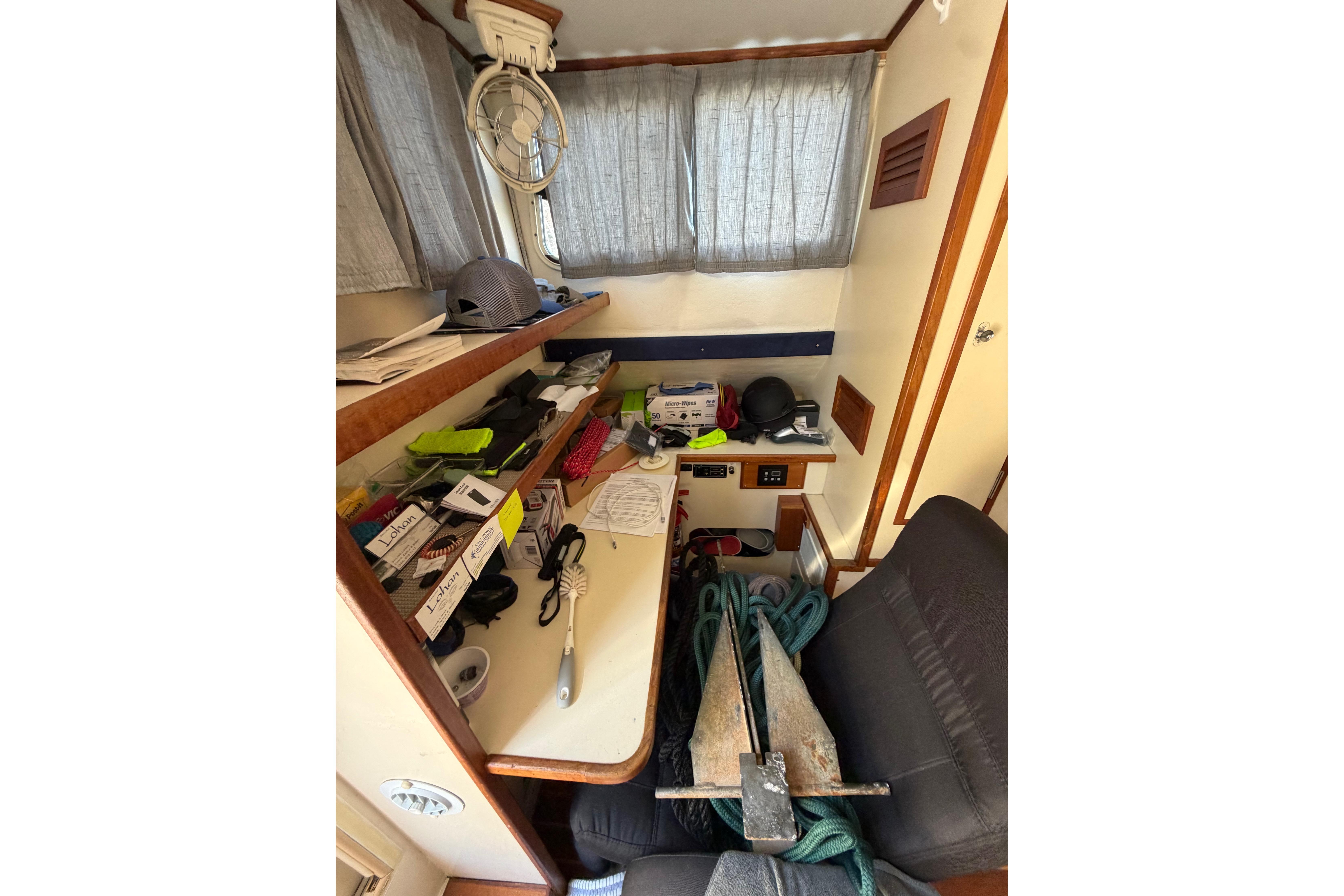 Interior of a 1997 Rosborough Trawler with cluttered desk and nautical equipment.