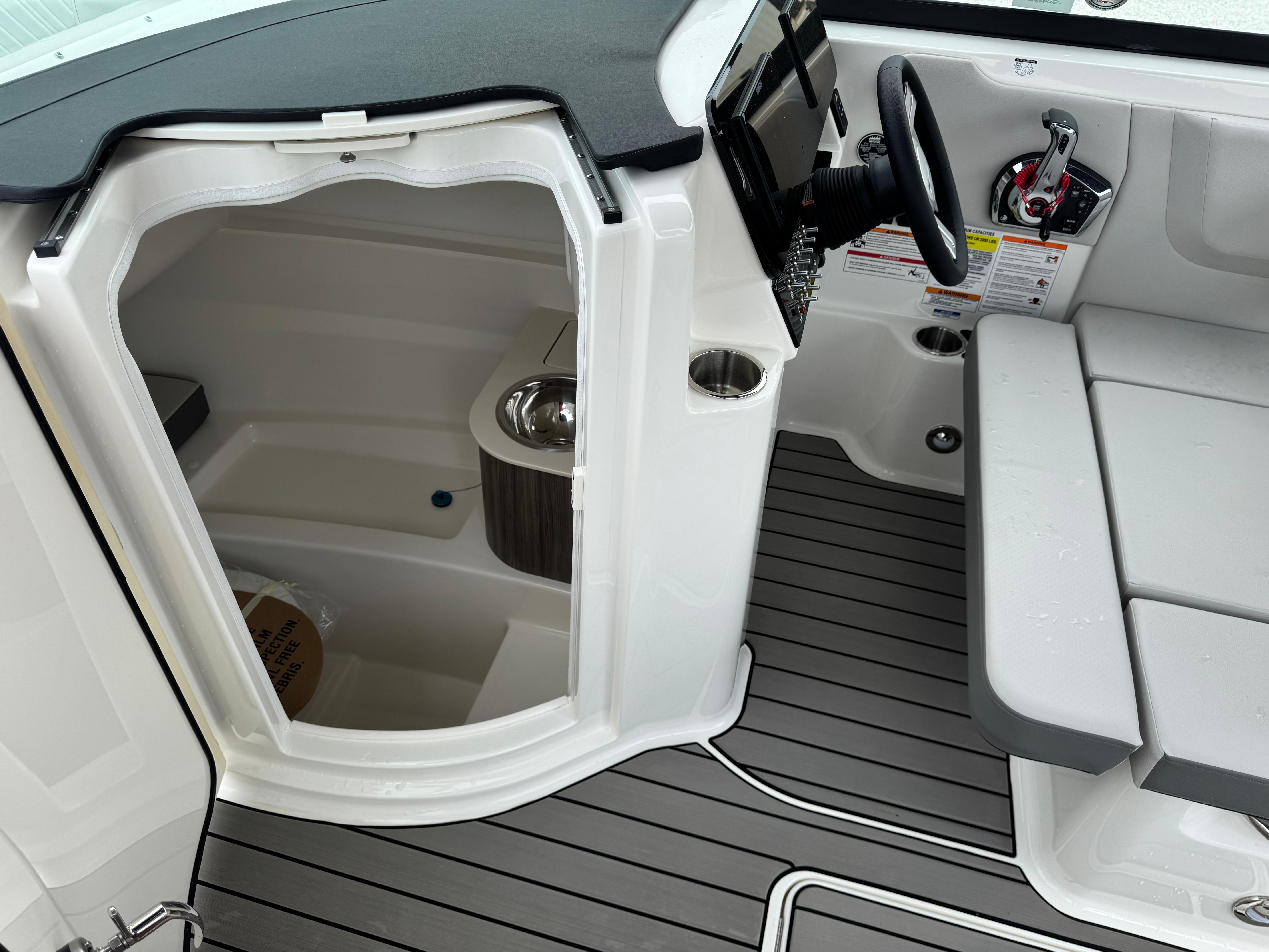 2025 Sea Ray SDX 250 boat interior with helm, seating, and compact cabin space.