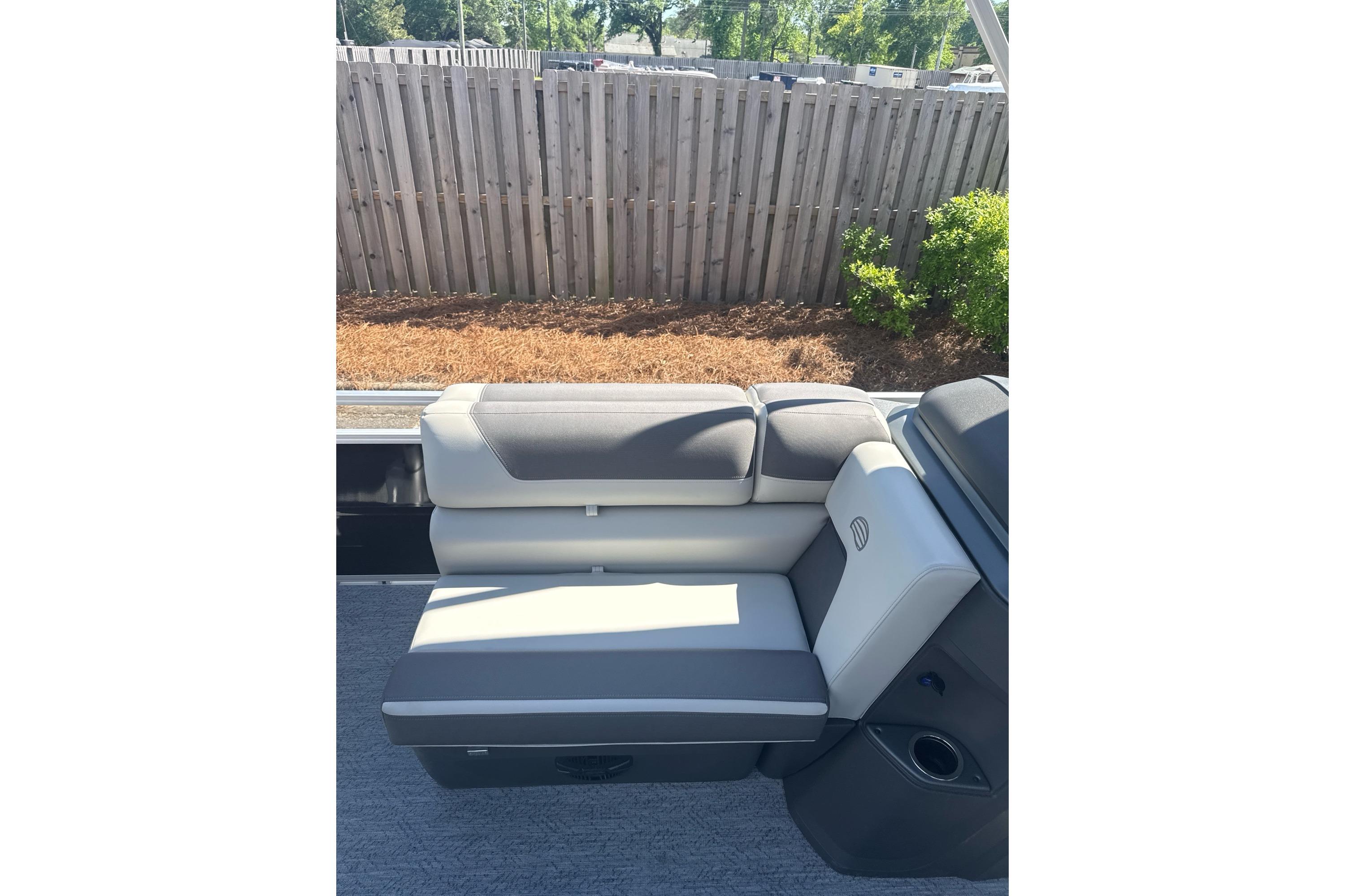 2026 Sun Tracker Fishin' Barge 20 DLX boat seat with gray upholstery.