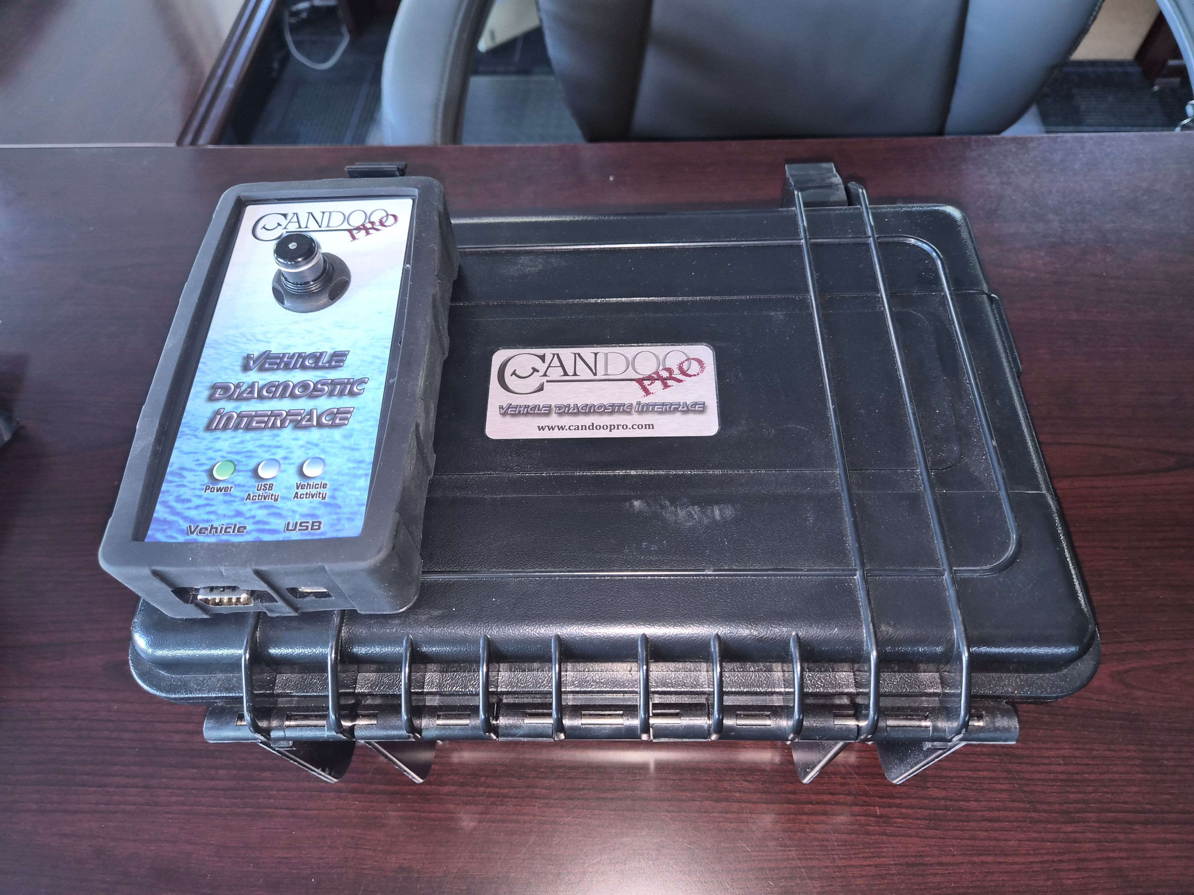 CANDoo Pro vehicle diagnostic interface on a table.