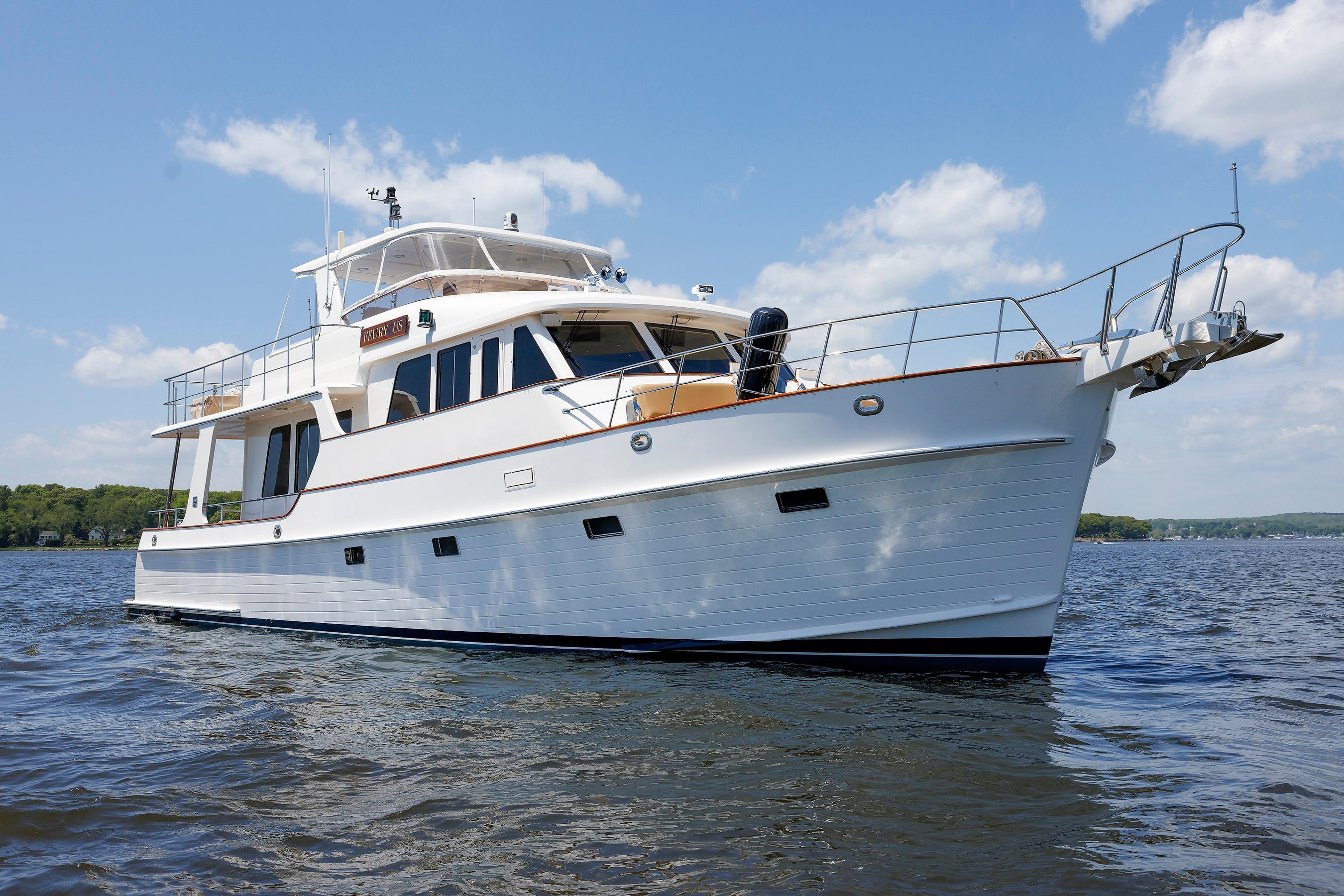 2007 Grand Banks 59 Aleutian RP yacht on calm water under blue sky.
