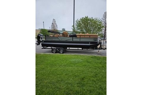 2026 Ranger 220FC boat on trailer, parked outdoors with green grass and trees.