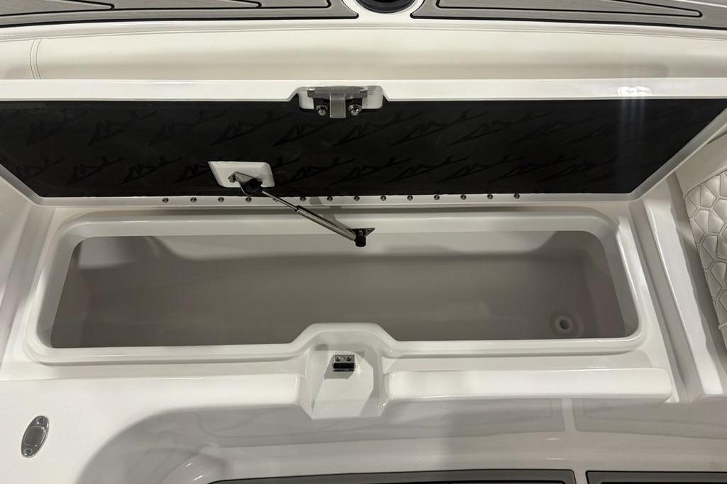 Open storage compartment on 2026 Tidewater 3100 Carolina Bay boat, featuring sleek design and ample space.