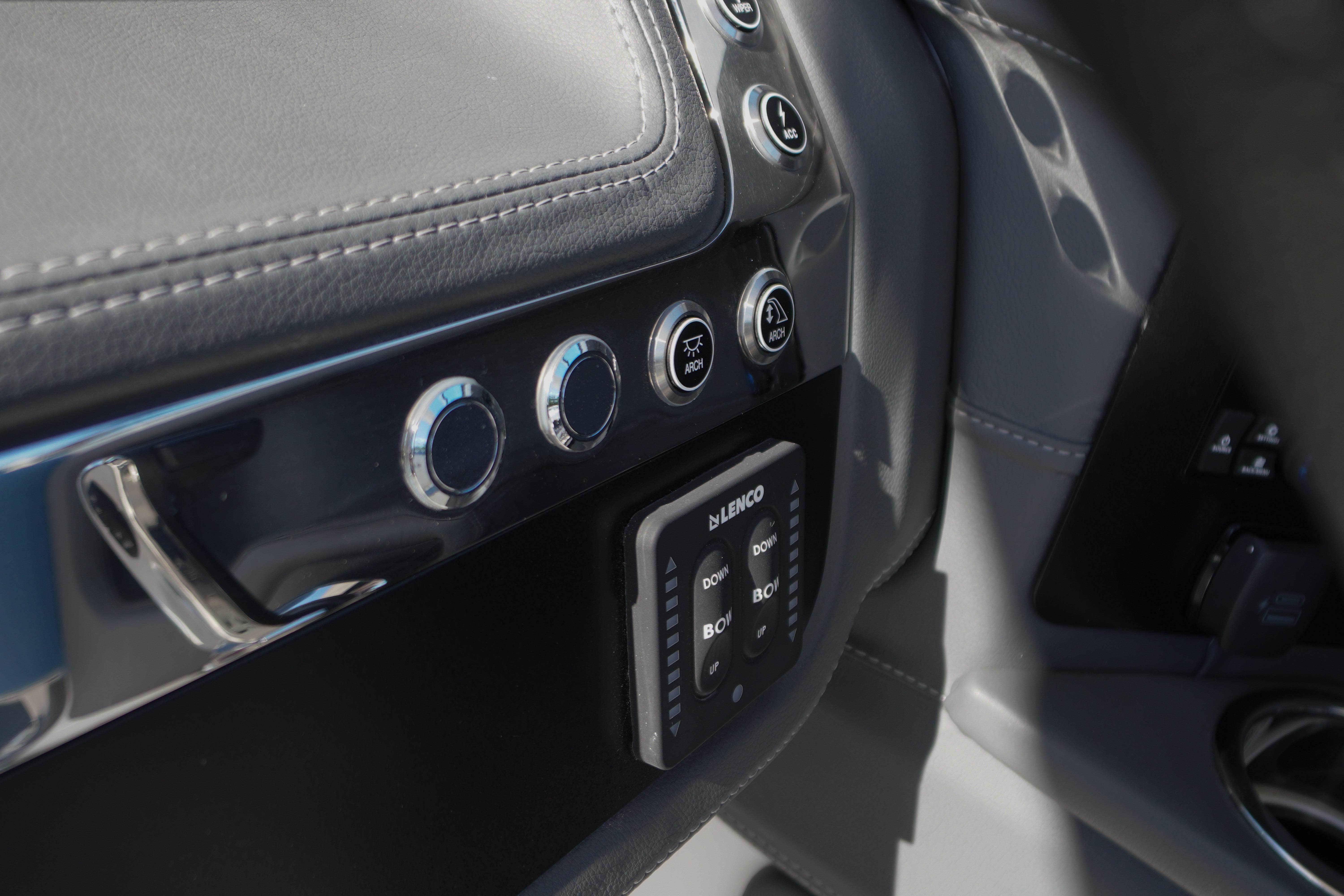 Control panel of 2026 Chaparral 270 OSX boat with buttons and Lenco trim tab switches.