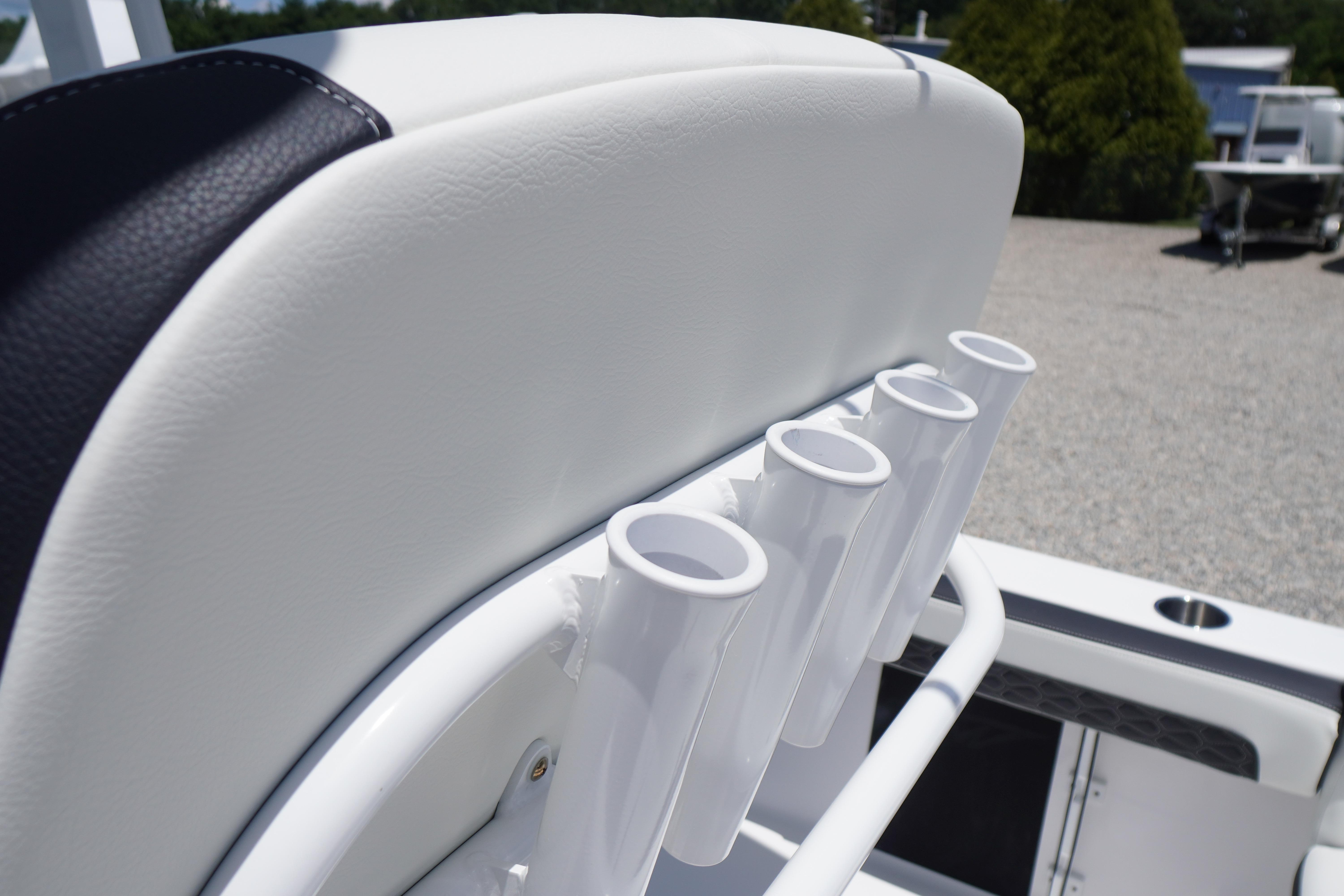 Rod holders on a 2027 Tidewater 220 LXF boat, featuring sleek white upholstery.