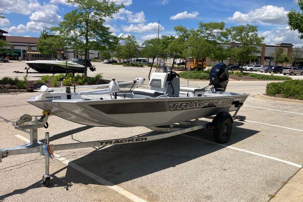 2026 Tracker Bass Tracker Classic CC boat on trailer in parking lot.
