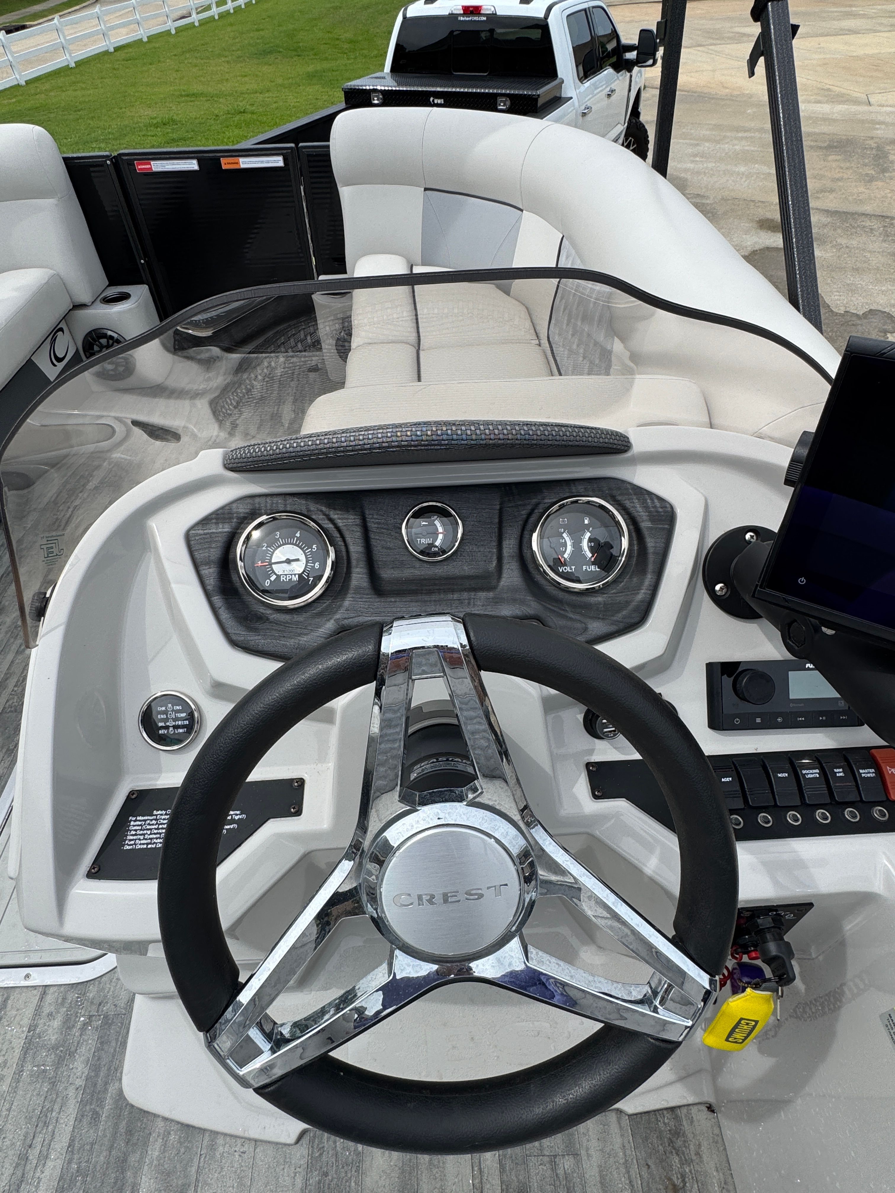 Steering wheel and dashboard of a 2022 Crest Classic DLX 220 boat.