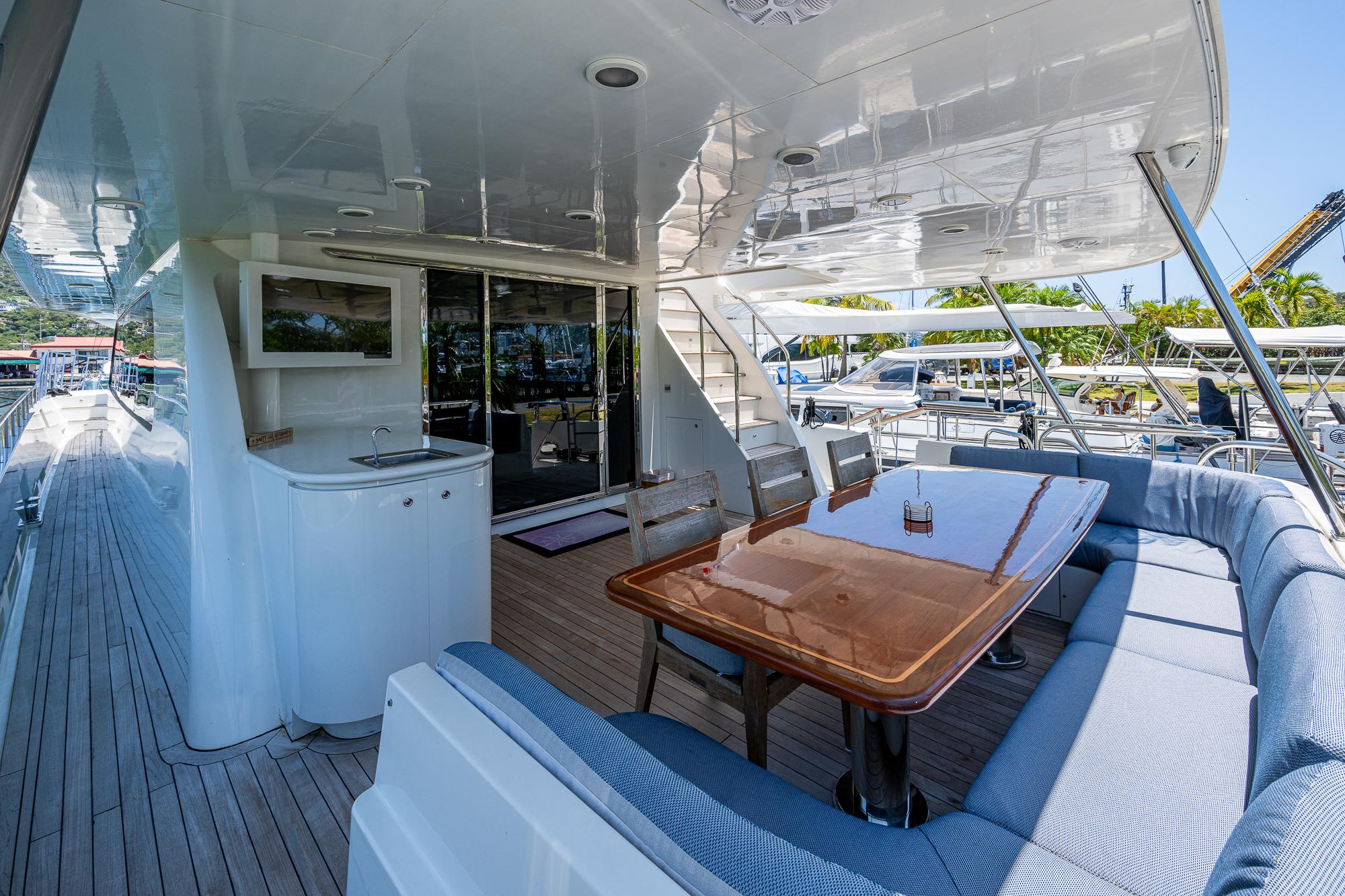 2007 Cheoy Lee Bravo Flybridge Motor Yacht deck with seating and dining area.