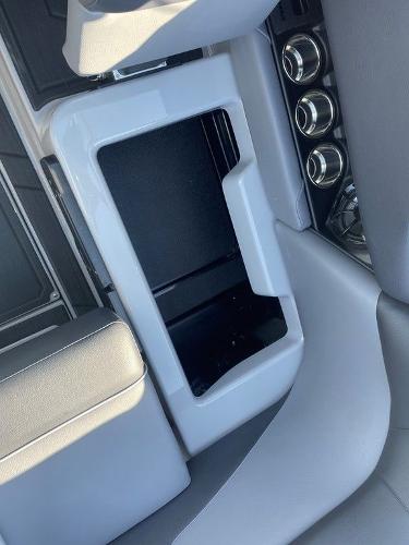 2025 Moomba Mondo boat interior with storage compartment and cup holders.