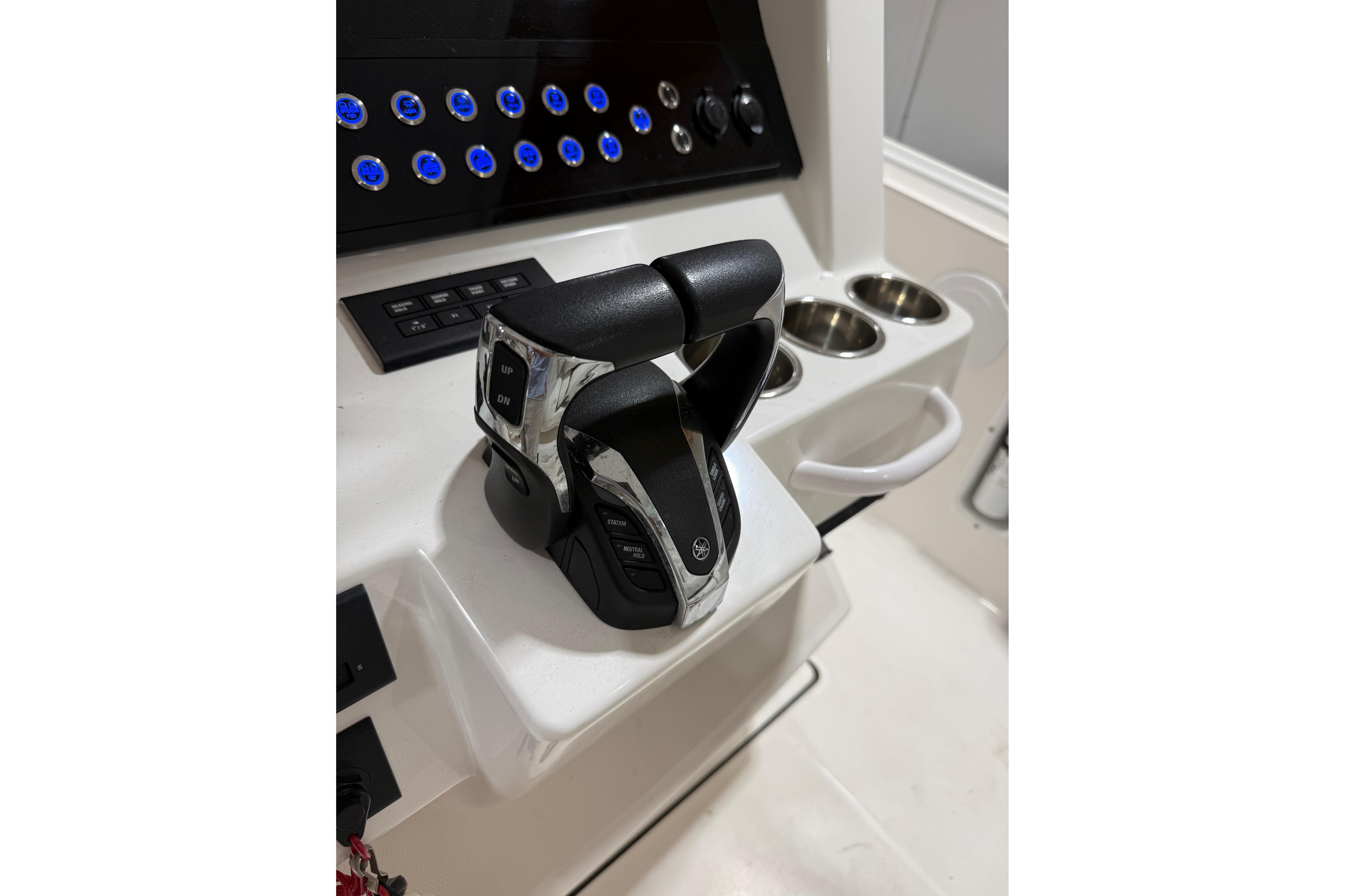 Throttle controls on a 2022 Edgewater 280CC boat dashboard with illuminated buttons.