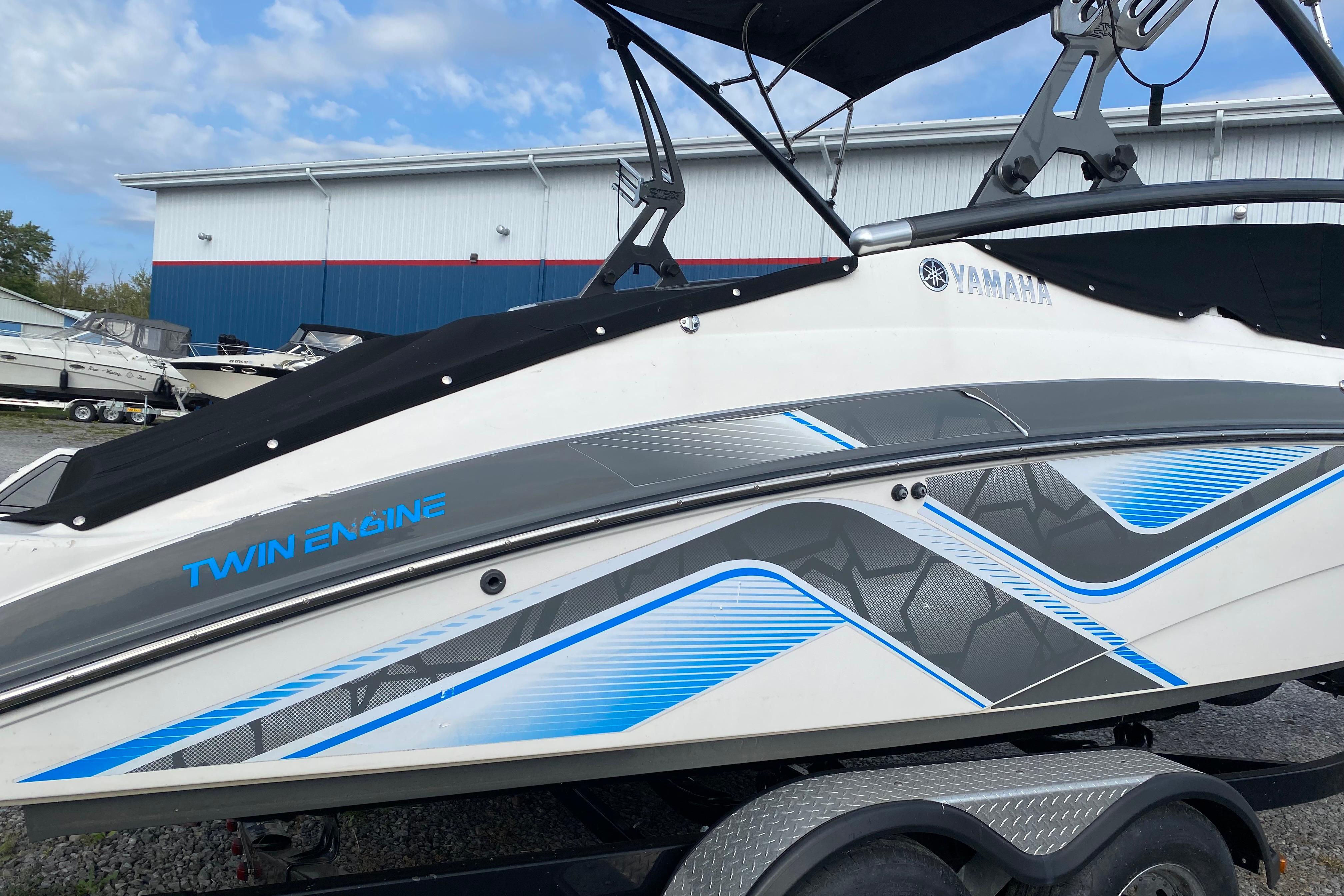 2015 Yamaha Boats 212X with twin engines, sleek design, and modern graphics.
