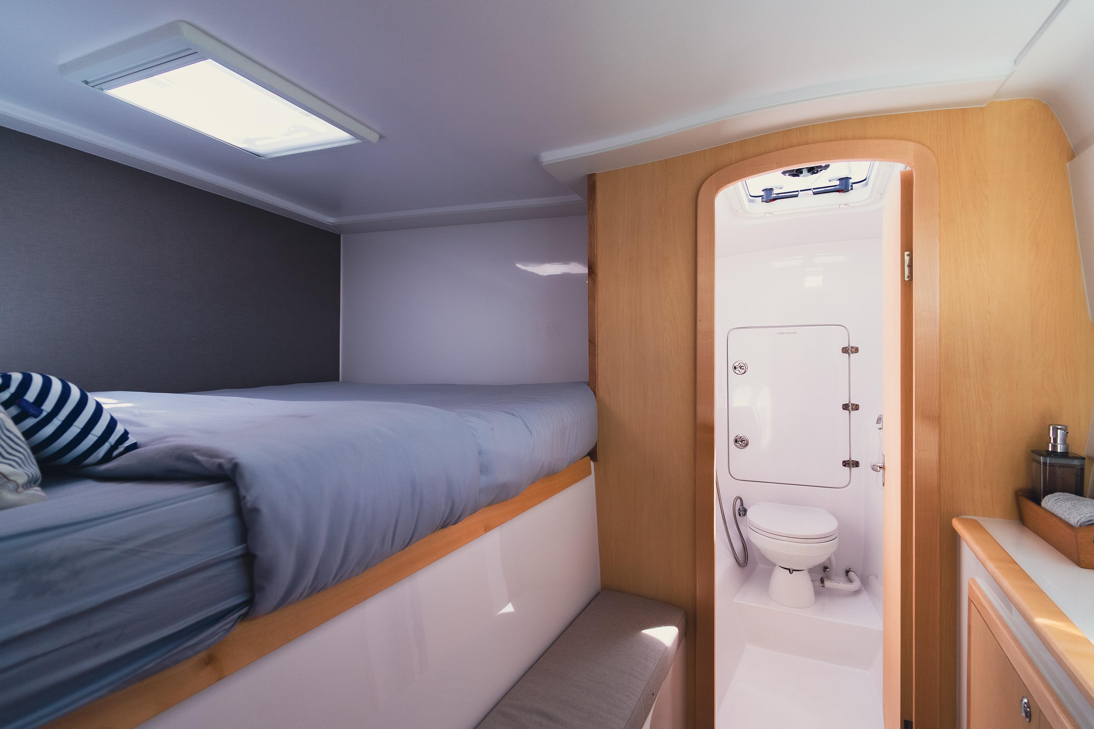Interior of 2026 Seawind 1160XL yacht cabin with bed and bathroom.
