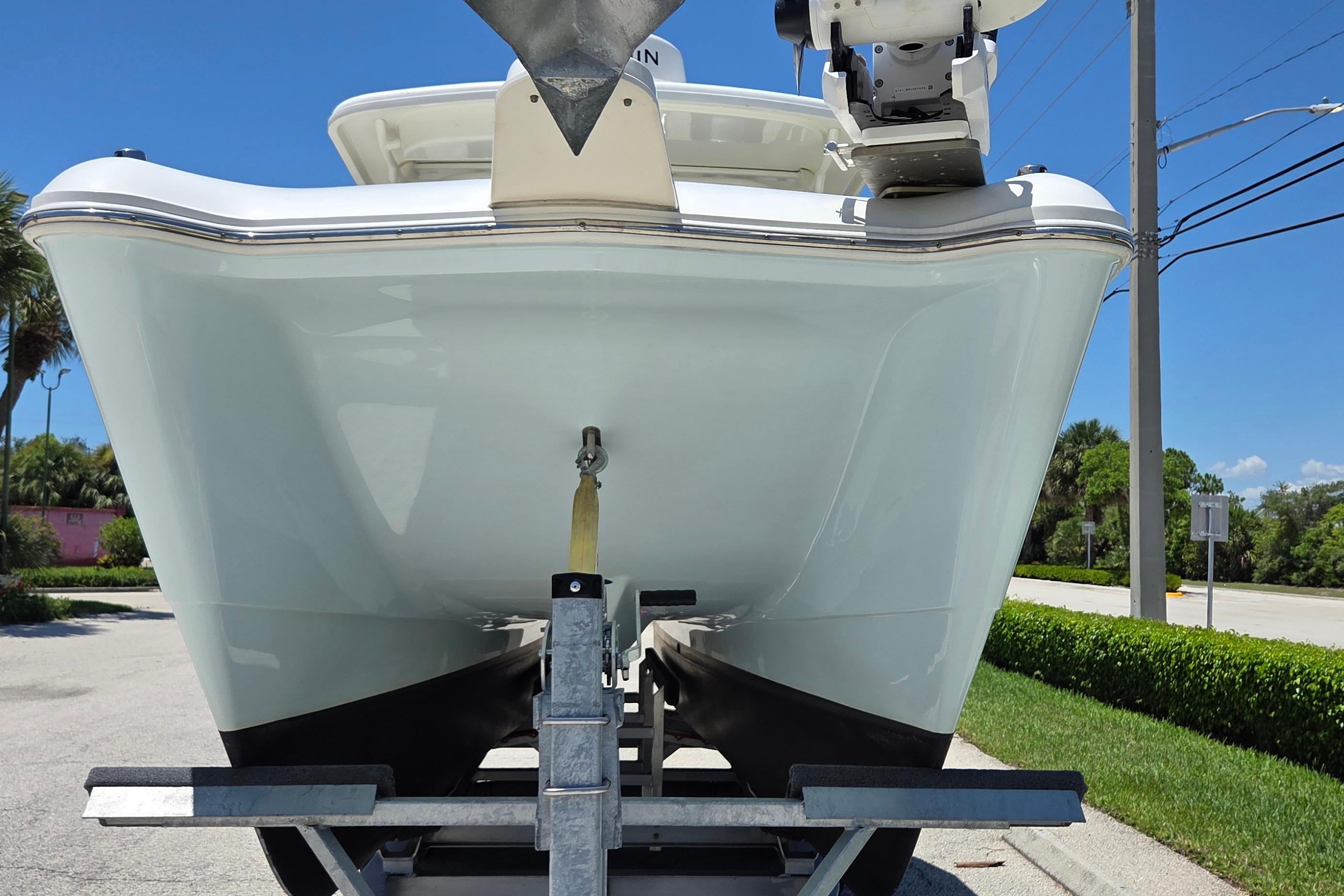 2022 World Cat 255 DC boat on trailer, viewed from the front, outdoors.