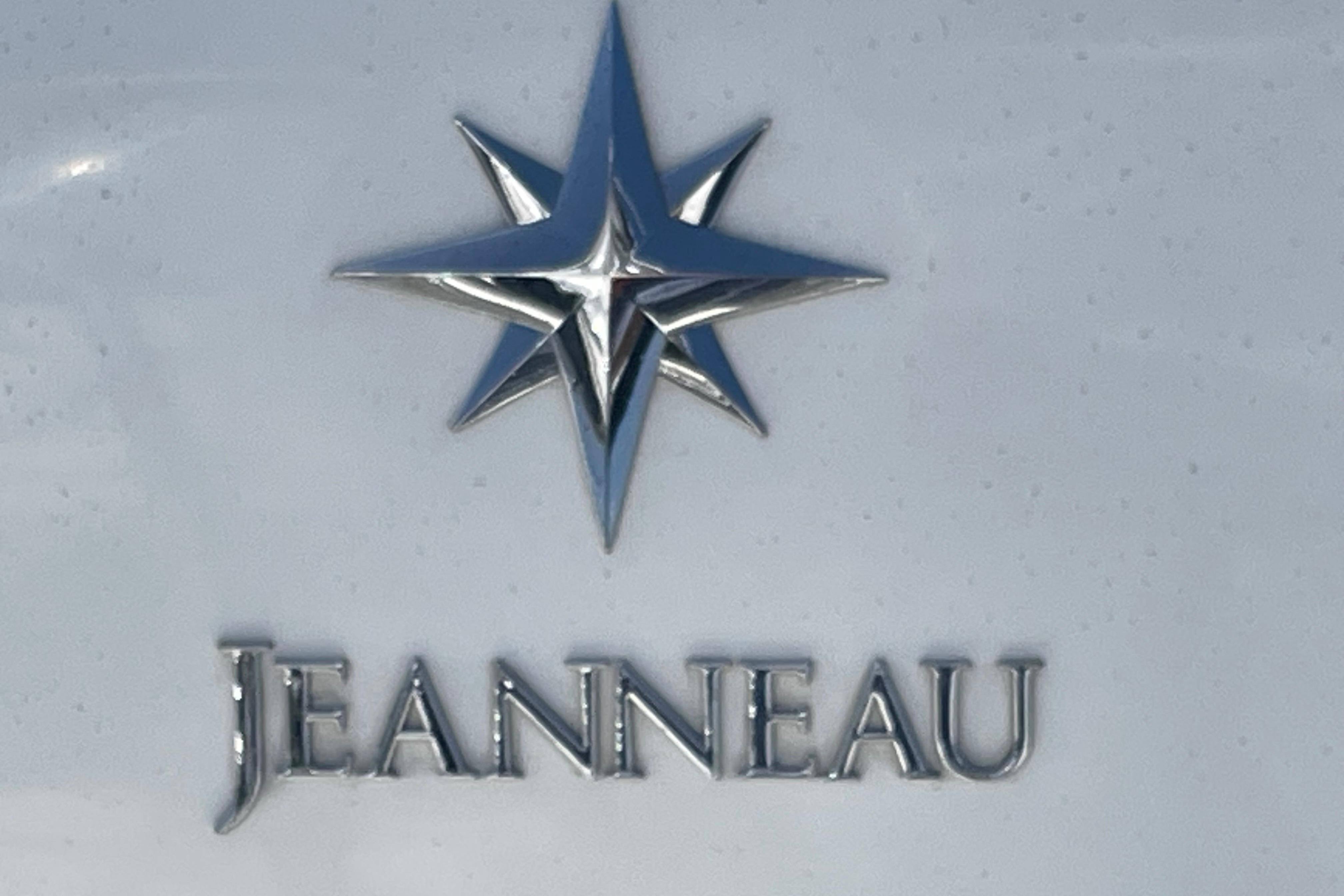 Jeanneau logo on 2007 Sun Odyssey 39 DS sailboat, featuring a star emblem.