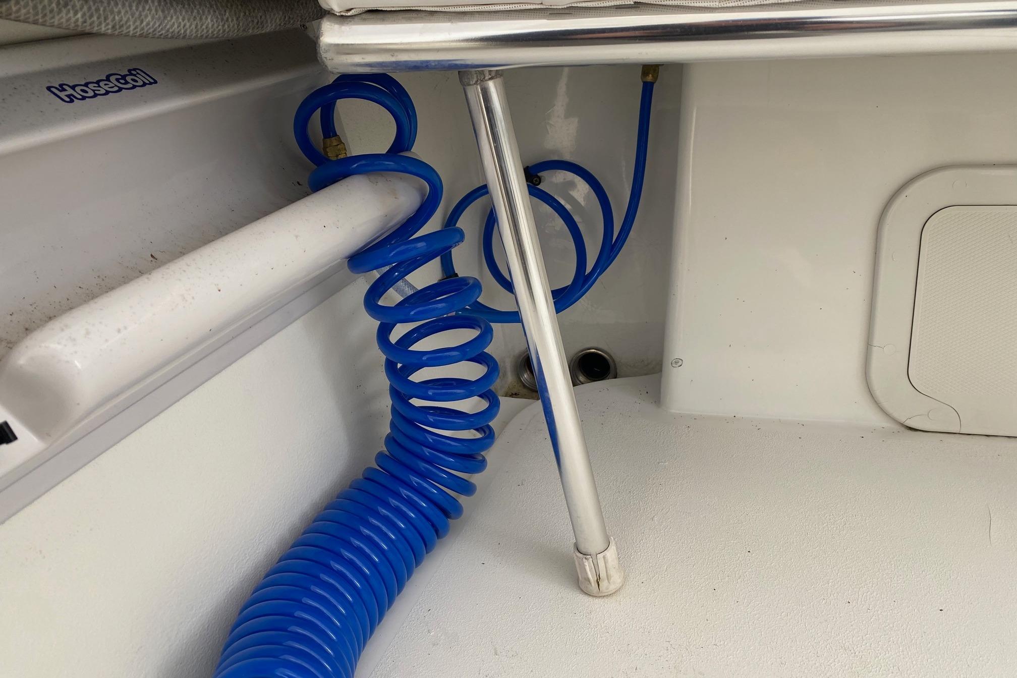 Blue coiled hose in 2007 Roth Bilt 24 CC boat interior.