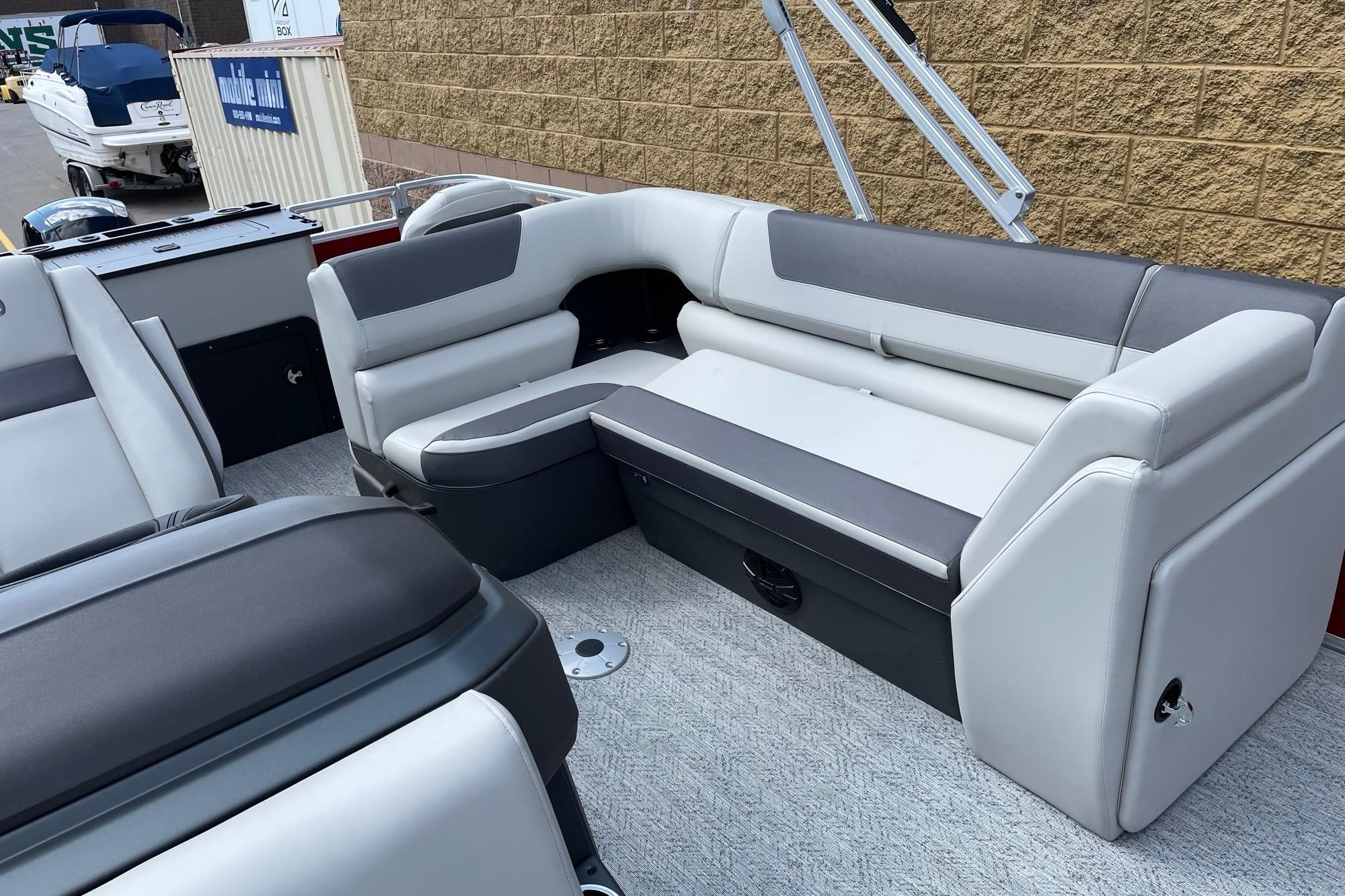 2026 Sun Tracker Fishin' Barge 22 DLX interior with gray and white seating.