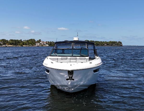 2020 Cruisers Yachts 38 GLS OB on open water, front view.
