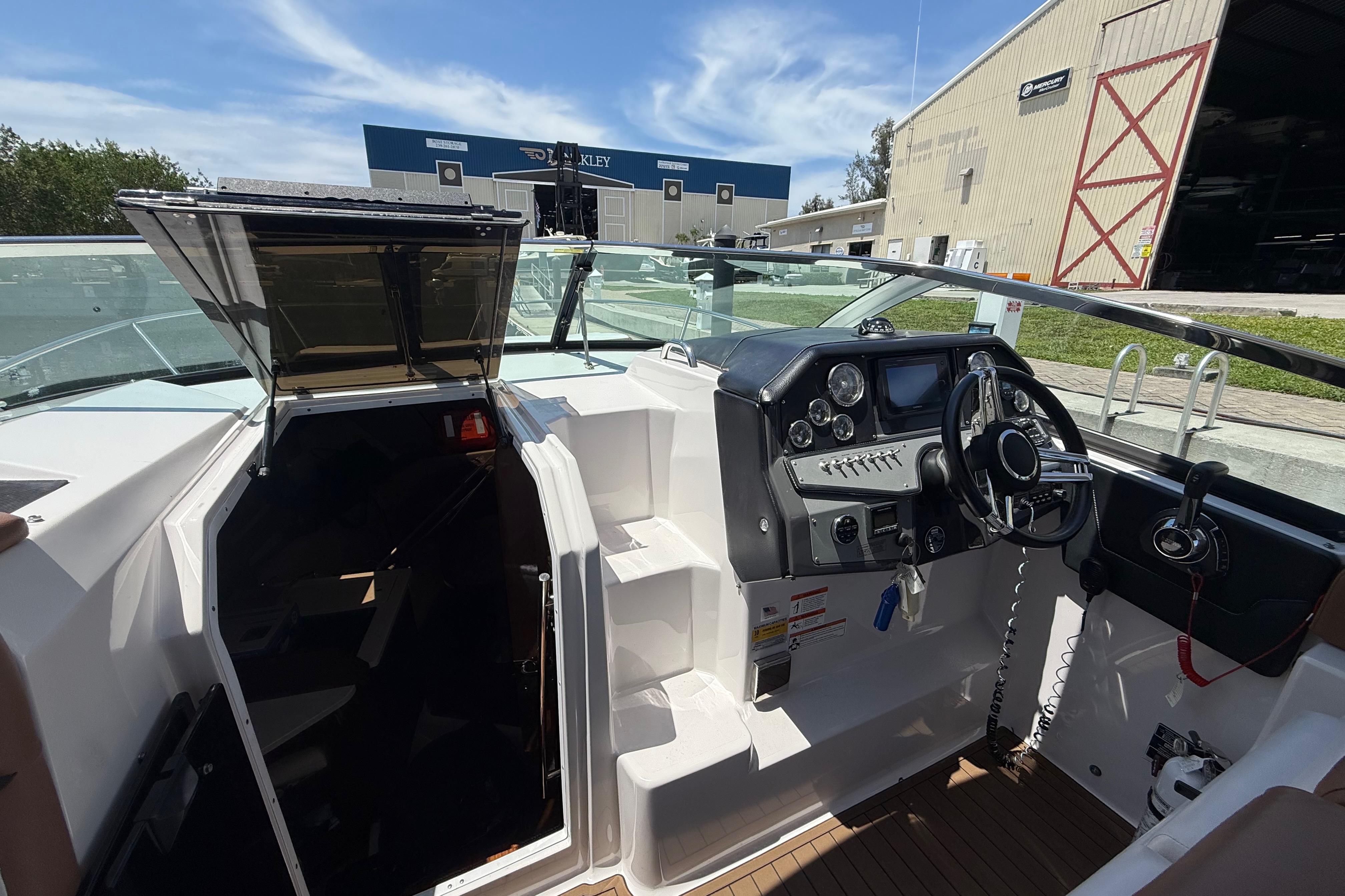 2017 Four Winns V275 boat cockpit with steering wheel and control panel.
