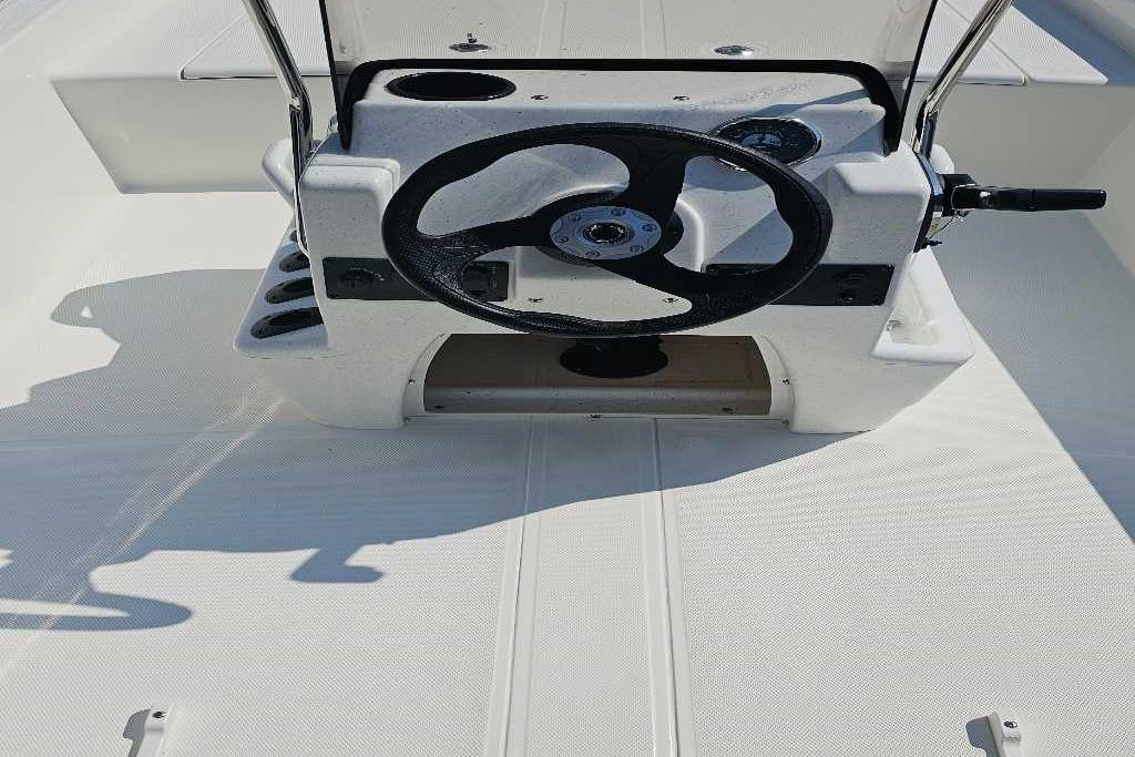 2026 Mako Pro Skiff 15 CC boat console with steering wheel and controls.