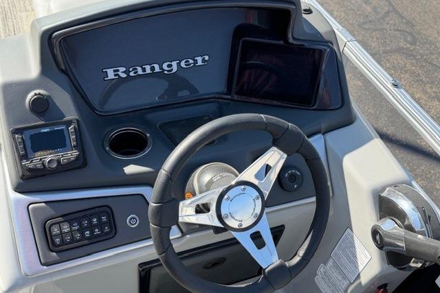 2025 Ranger Reata 223C boat dashboard with steering wheel and control panel.