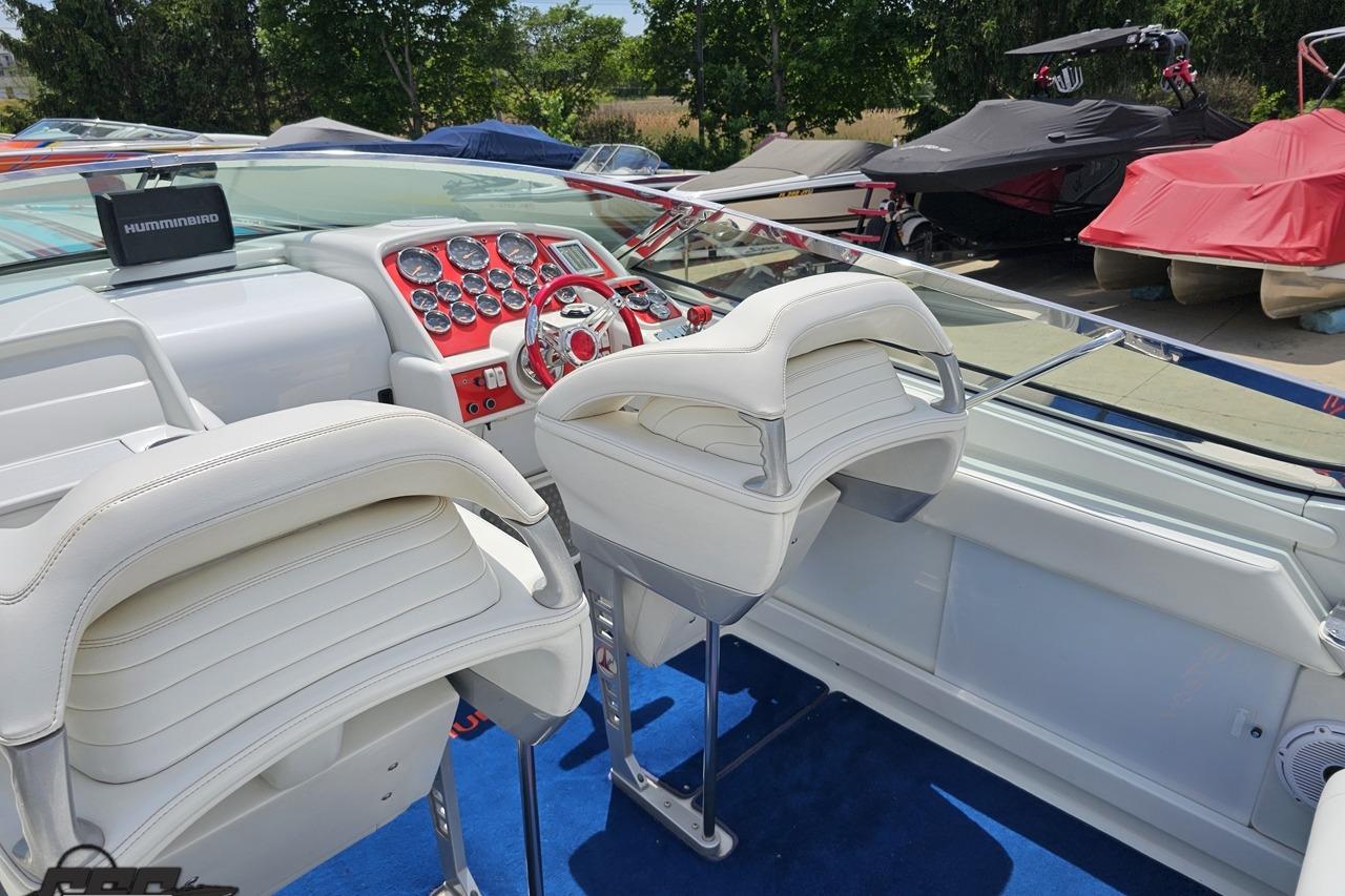 2002 Formula 382 FASTech boat interior with white seats and red dashboard.
